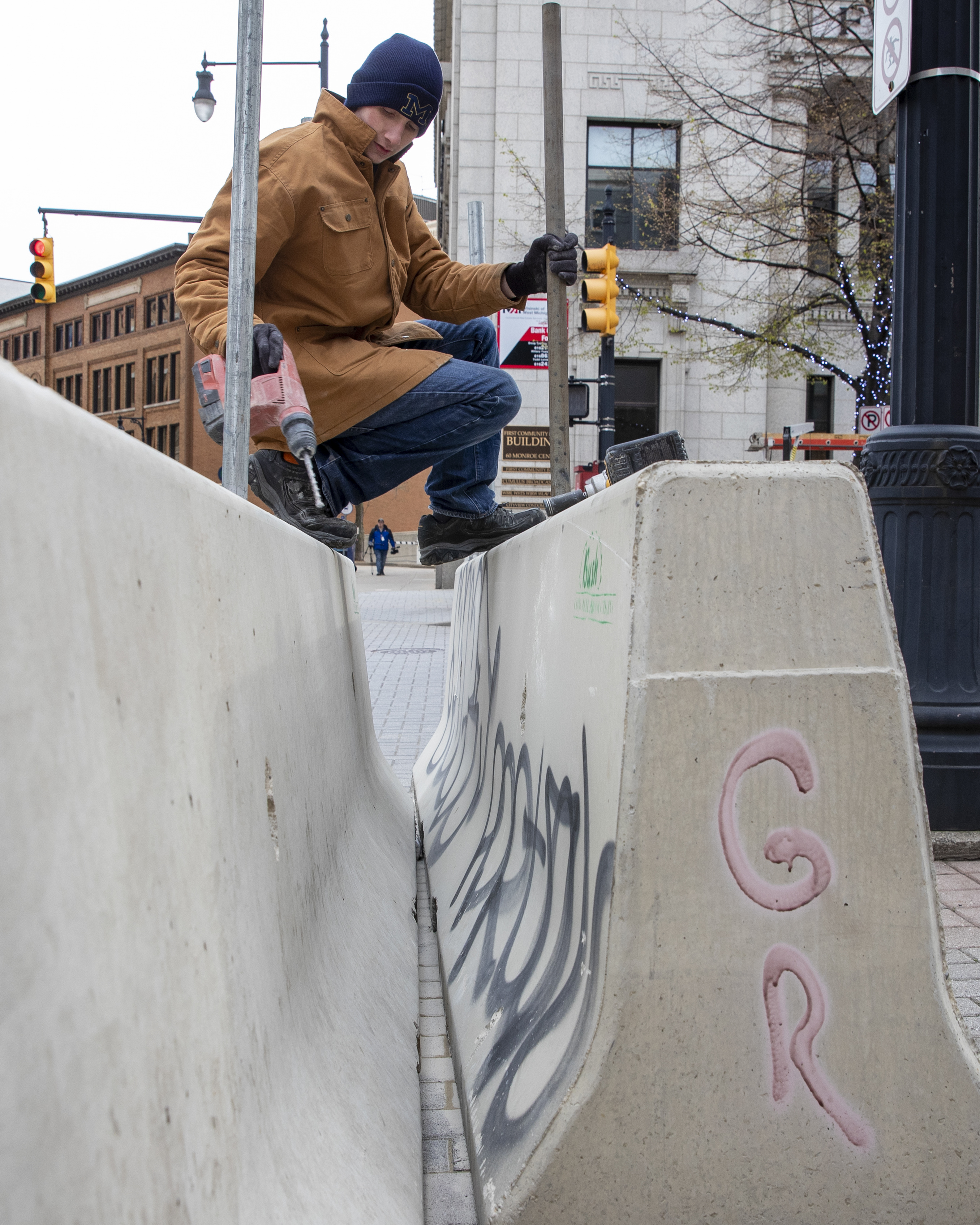 Cole Bond, from Fence Consultants of West Michigan, puts up barricades in downtown Grand Rapids on Tuesday, April 20, 2021, as a jury deliberates fate of Derek Chauvin in death of George Floyd. A riot on May 30, 2020, caused significant property damage in the aftermath of a peaceful protest following the death of Floyd in Minneapolis. (Cory Morse | MLive.com)