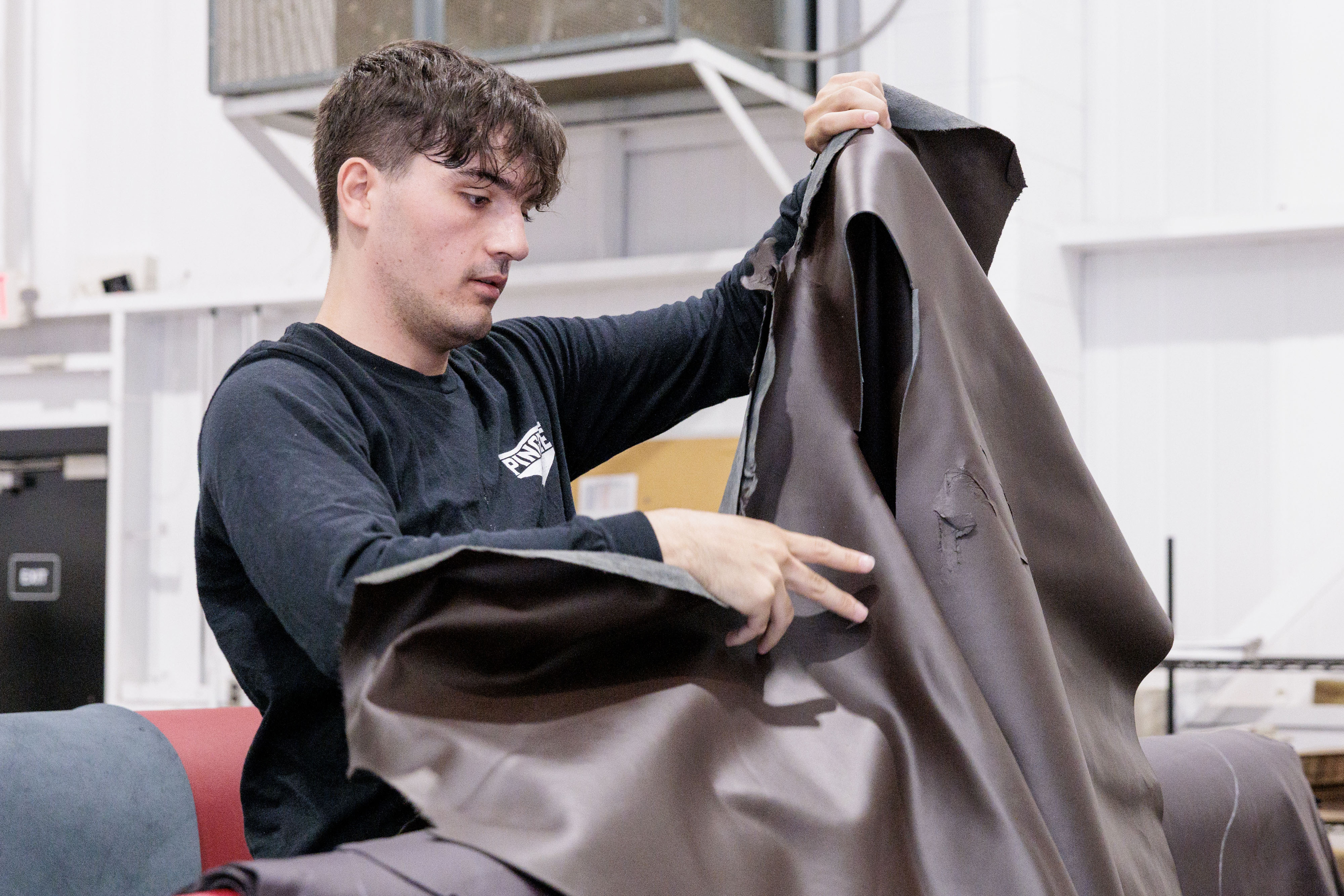 Pingree Detroit’s Eric Rranxburgaj sorts through automotive leather donated by Pangea at the automotive supplier’s offices in Rochester Hills on Monday, Oct. 6 2025.