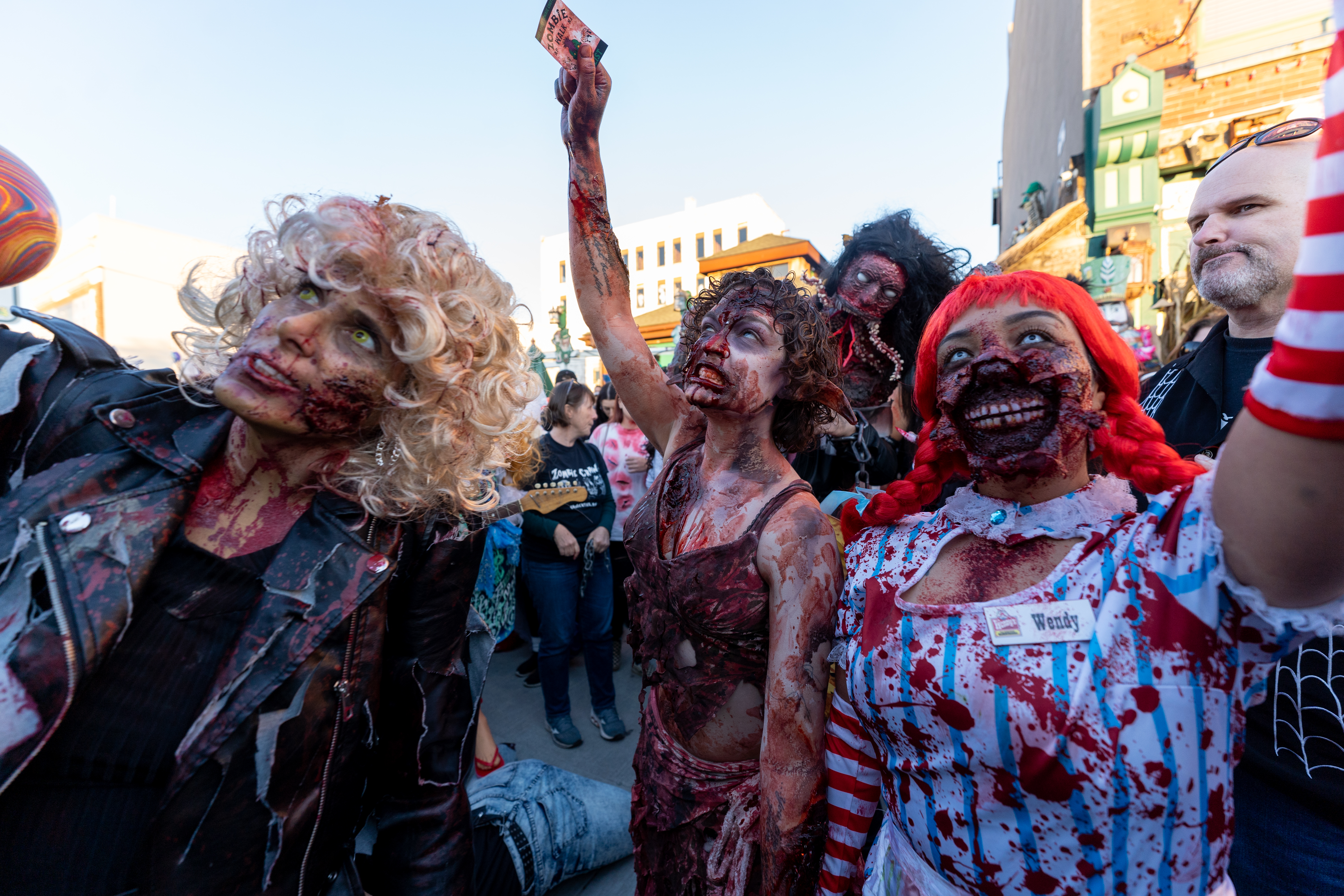 Zombies hold up their finalist tickets during the zombie costume contest single adult category during the 14th Asbury Park Zombie Walk in Asbury Park on Saturday, October 8, 2022. The zombie walk held its first themed year with the theme being 80's and 90's punk and metal.