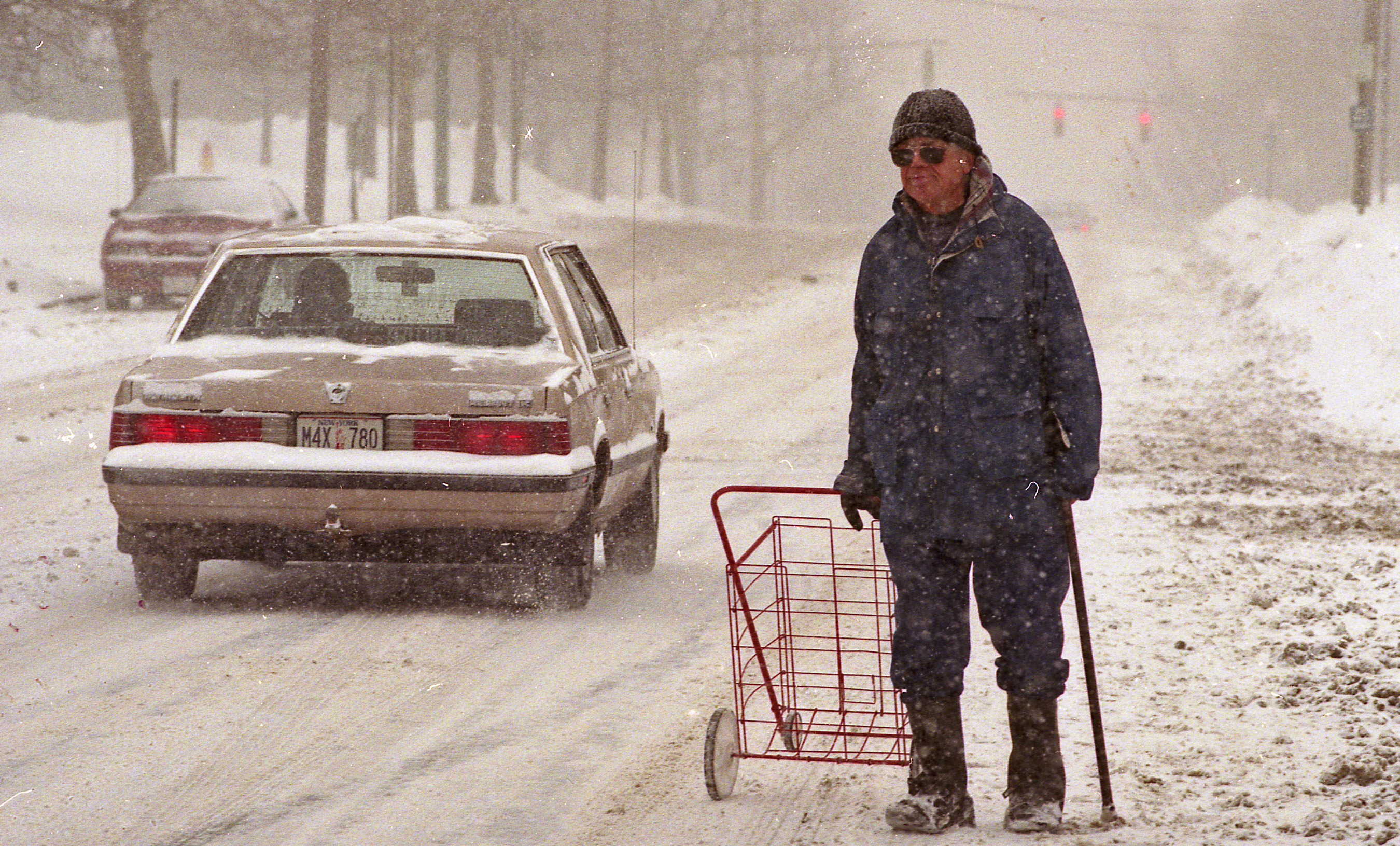 Fred Primo walks down Lodi Street in  Syracuse on March 13, 1993 after stocking up on groceries to get through the Blizzard of 1993..