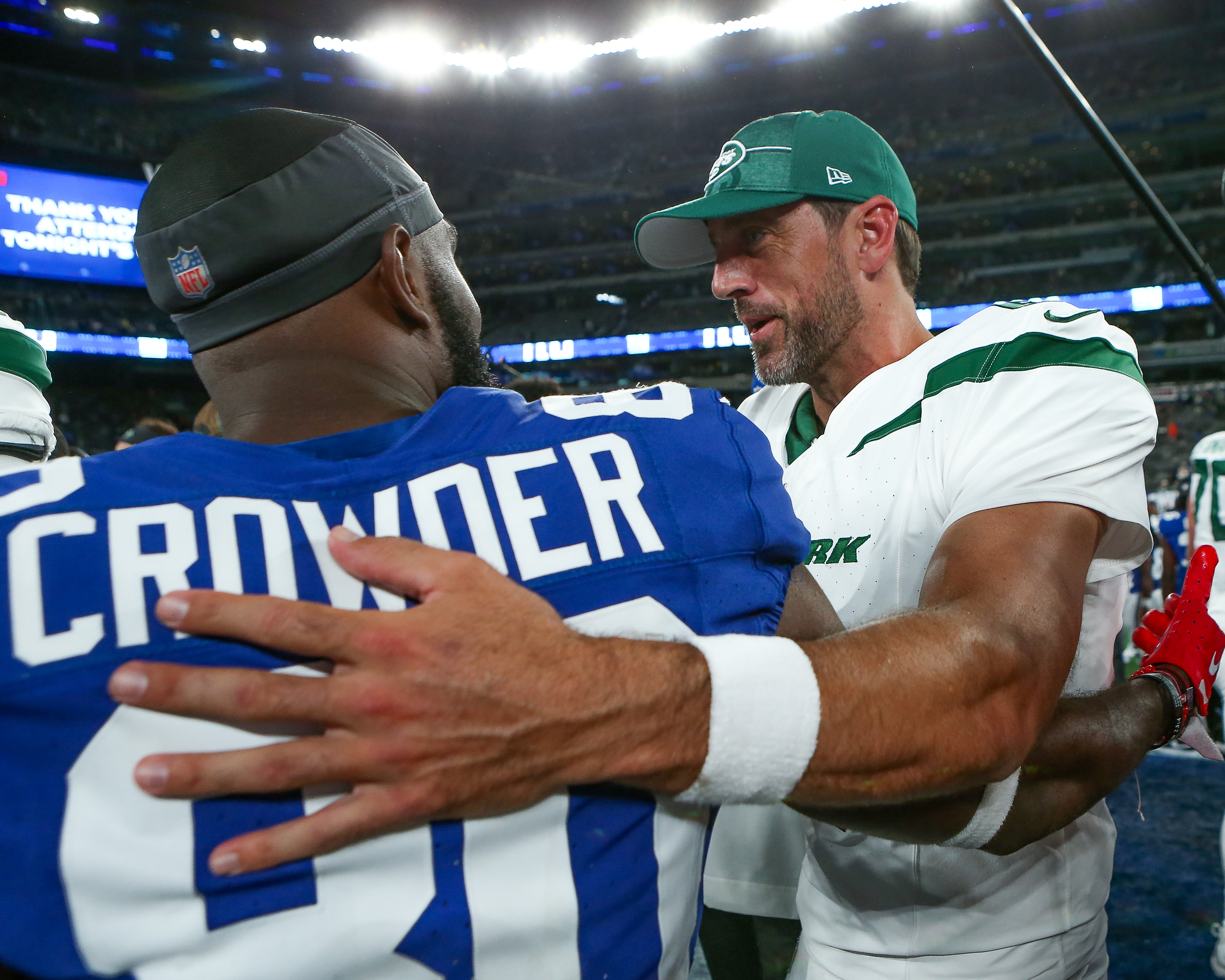 New York Jets offensive tackle Mekhi Becton (77) hugs quarterback Aaron  Rodgers (8) during an NFL football game against the New York Giants,  Saturday, Aug. 26, 2023 in East Rutherford, N.J. Jets