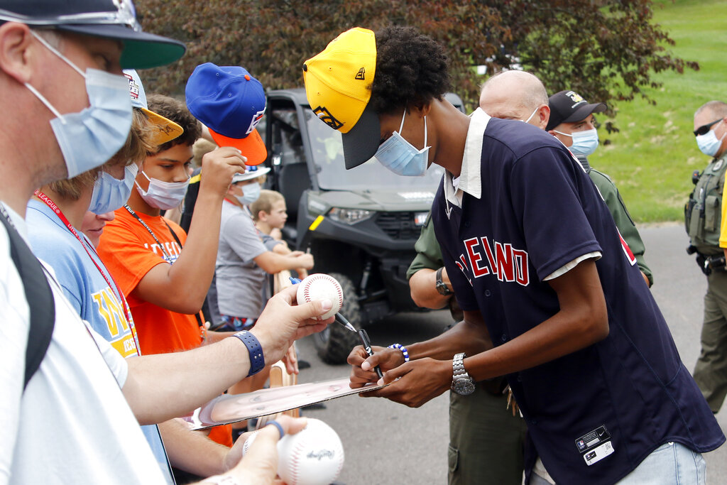 Cleveland Indians' Zach Plesac signs a hat for Nolensville, Tenn.'s Drew  Wagner (19) while they watch the game between Honolulu, Hawaii and  Hastings, Neb. during the a baseball game at the Little