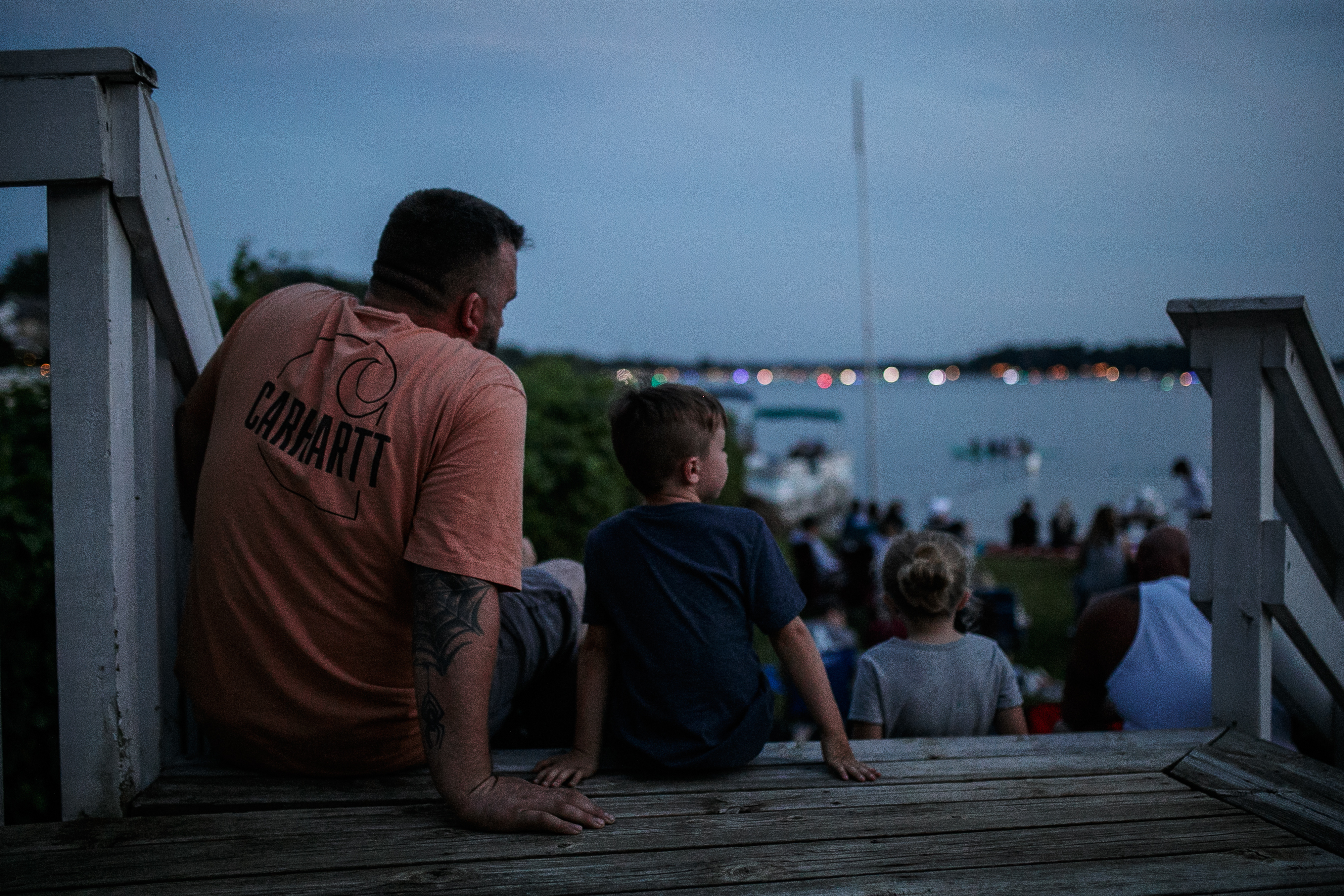 Families sit near the shore line in anticipation of the annual Lake Fenton Fireworks on the water in front of the Township hall on Saturday, June 2, 2022 in Fenton Township. (Jenifer Veloso | MLive.com)

