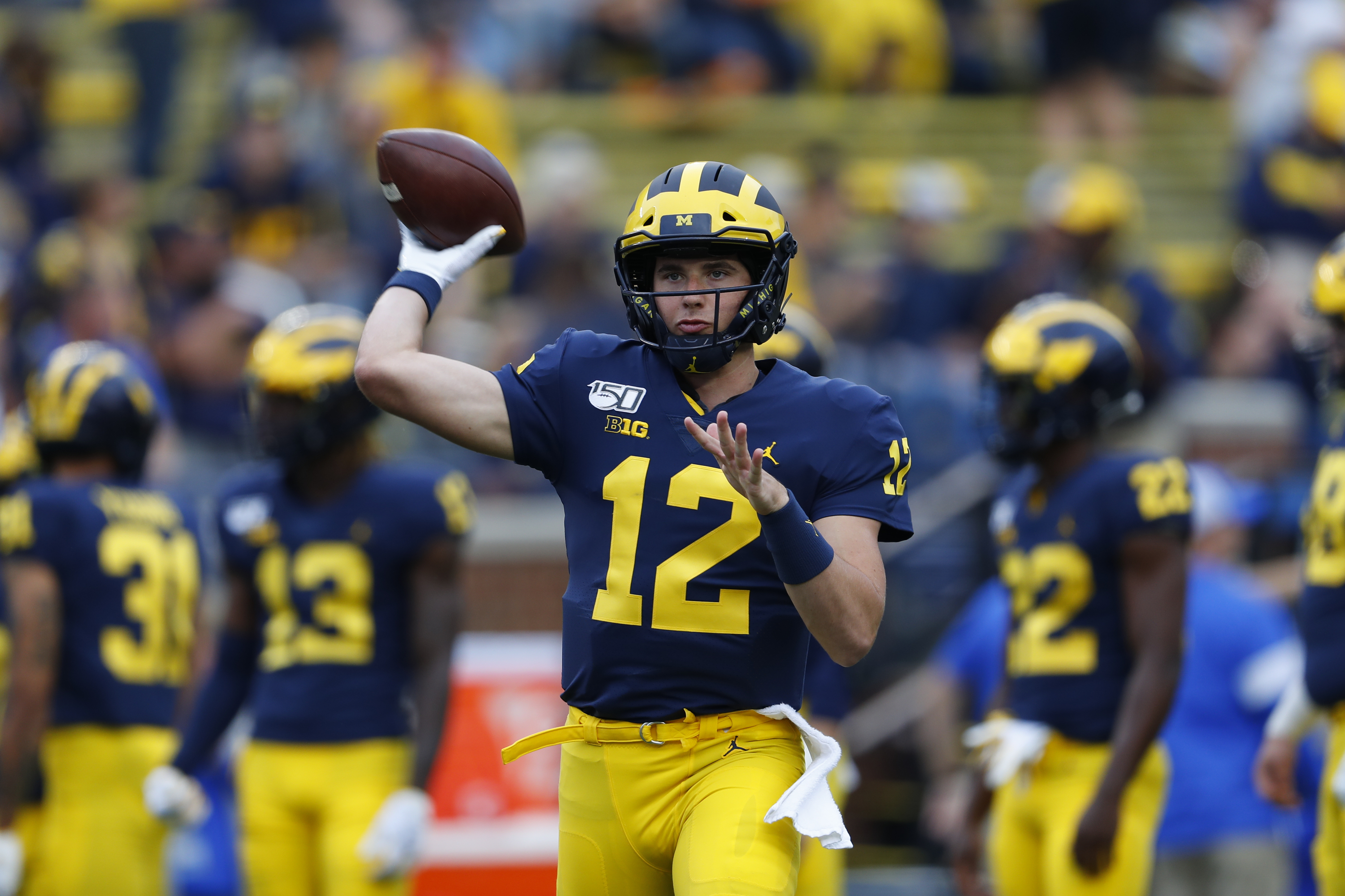 M Den selling Michigan football jerseys with players' names on the