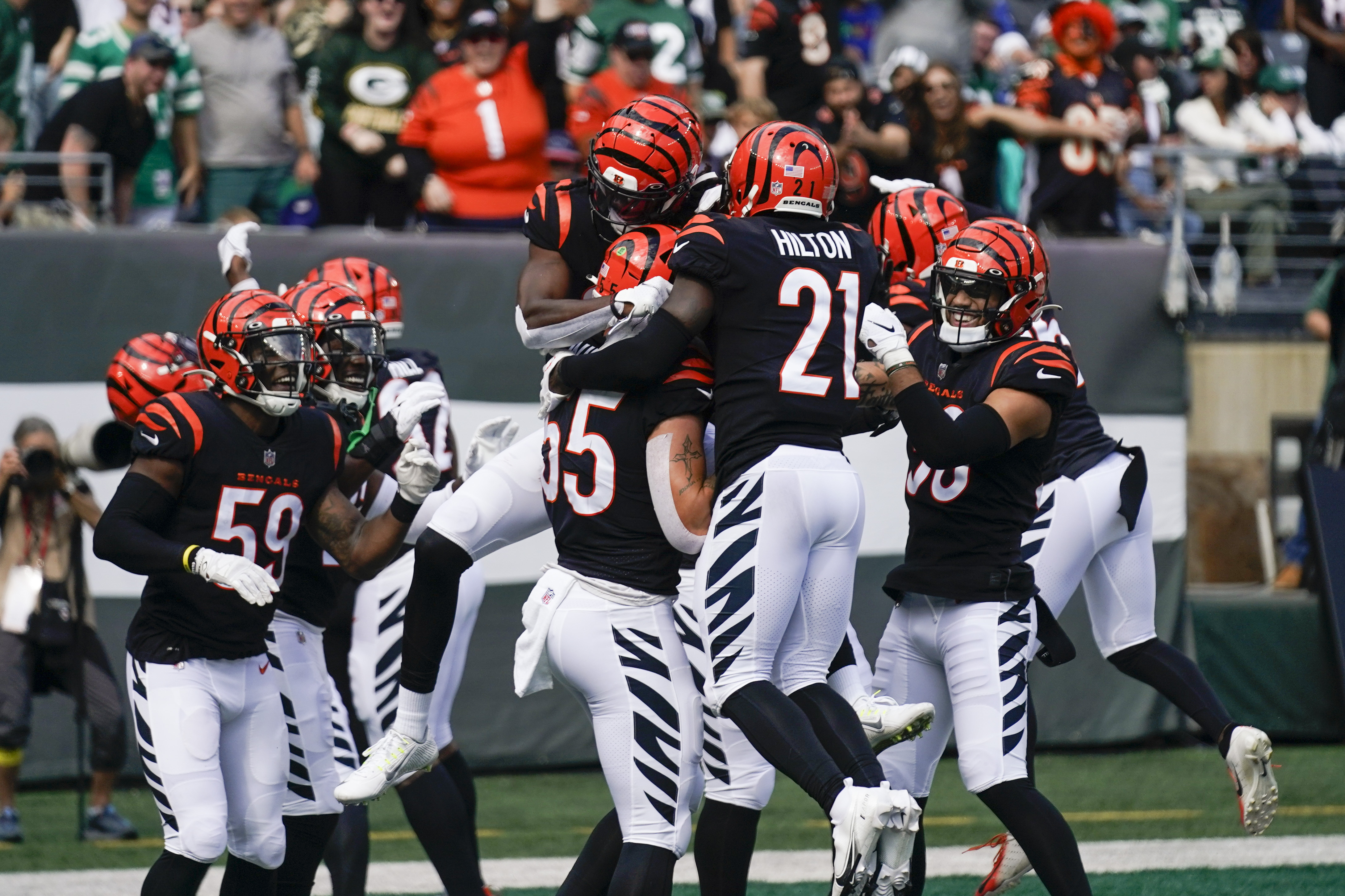 Cincinnati Bengals' Logan Wilson (55) runs past New York Jets' Max Mitchell  (61) after making an interception during the first half of an NFL football  game Sunday, Sept. 25, 2022, in East