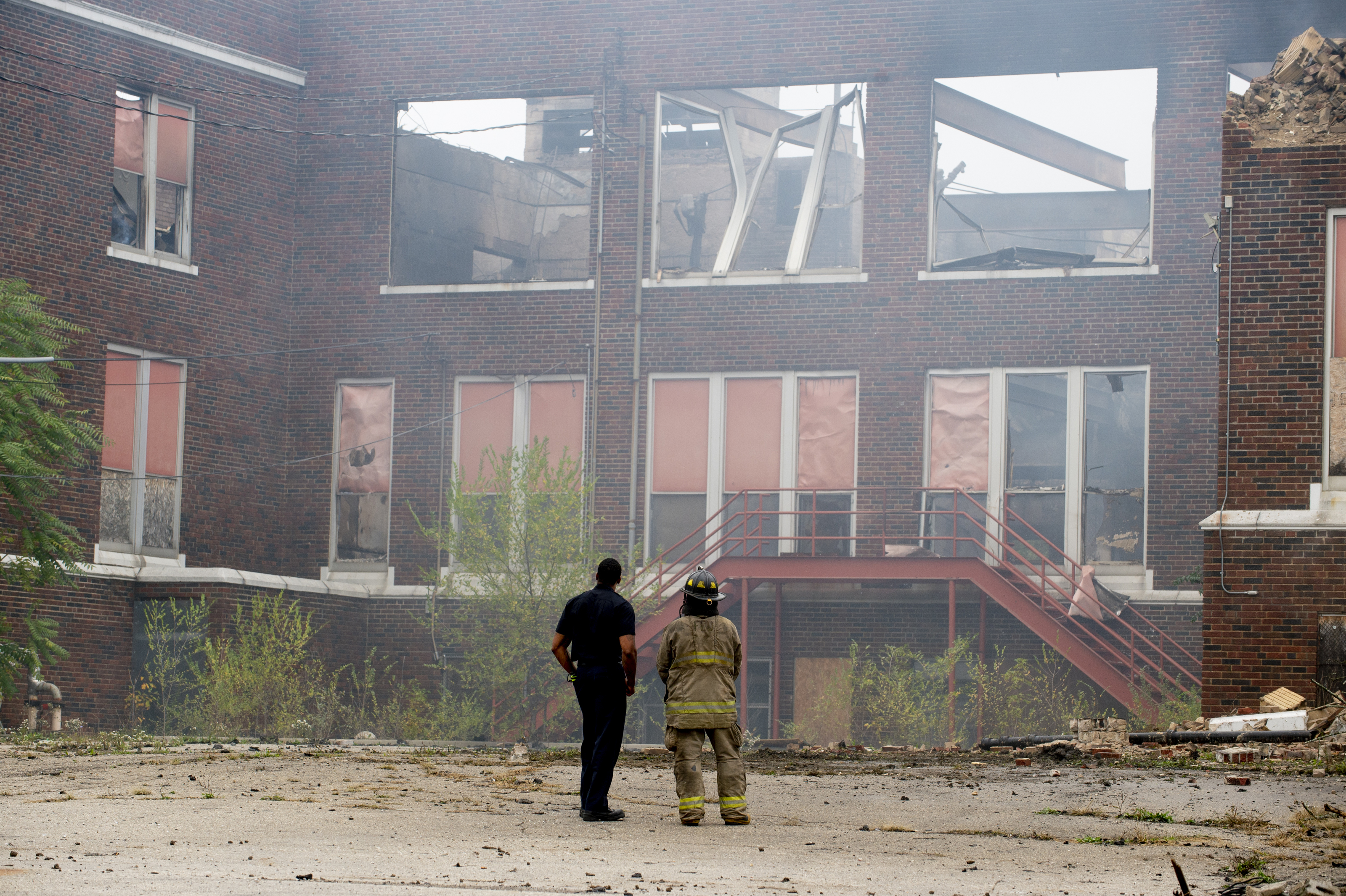 Firefighters work to contain a fire that started at about 12:30 a.m. on Thursday Oct. 7, 2021 at the former Washington Elementary School, located at 1400 N. Vernon Ave. in Flint. The building was built in 1922 before closing in 2013. (Jake May | MLive.com)