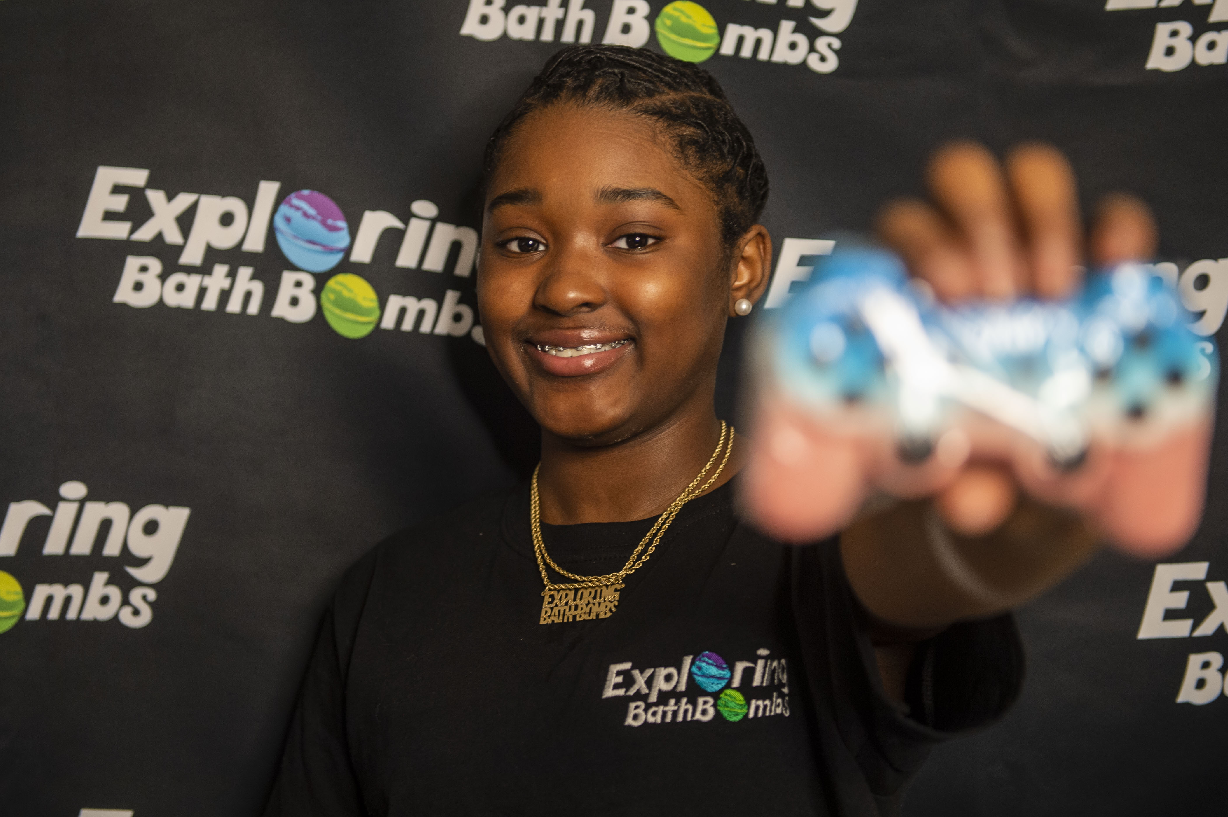 Sa'Veya Jackson, 11, holds one of her bath bomb creations for her business Exploring Bath Bombs on Thursday, April 22, 2021. (Kaytie Boomer | MLive.com)