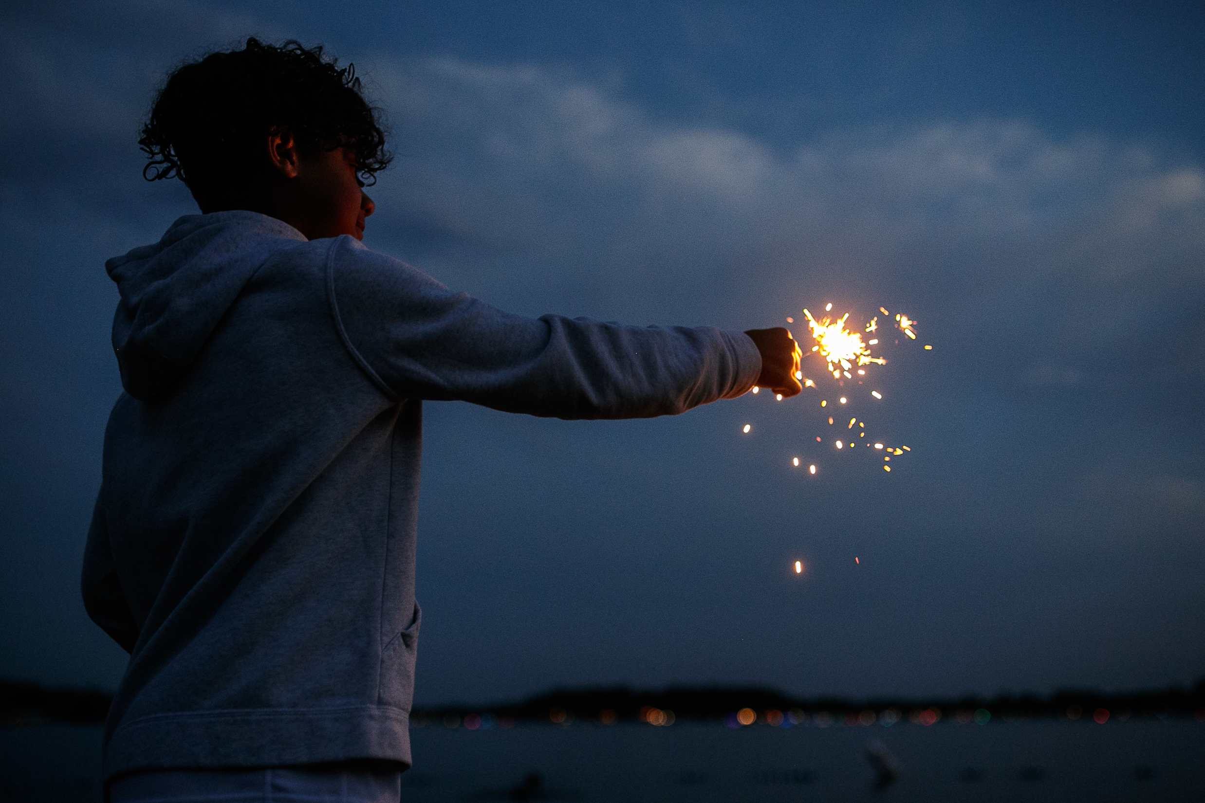Brodi Jourdan, 10,  plays with a sparkler while waiting for the start of the annual Lake Fenton Fireworks on the water in front of the Township hall on Saturday, June 2, 2022 in Fenton Township. (Jenifer Veloso | MLive.com)

