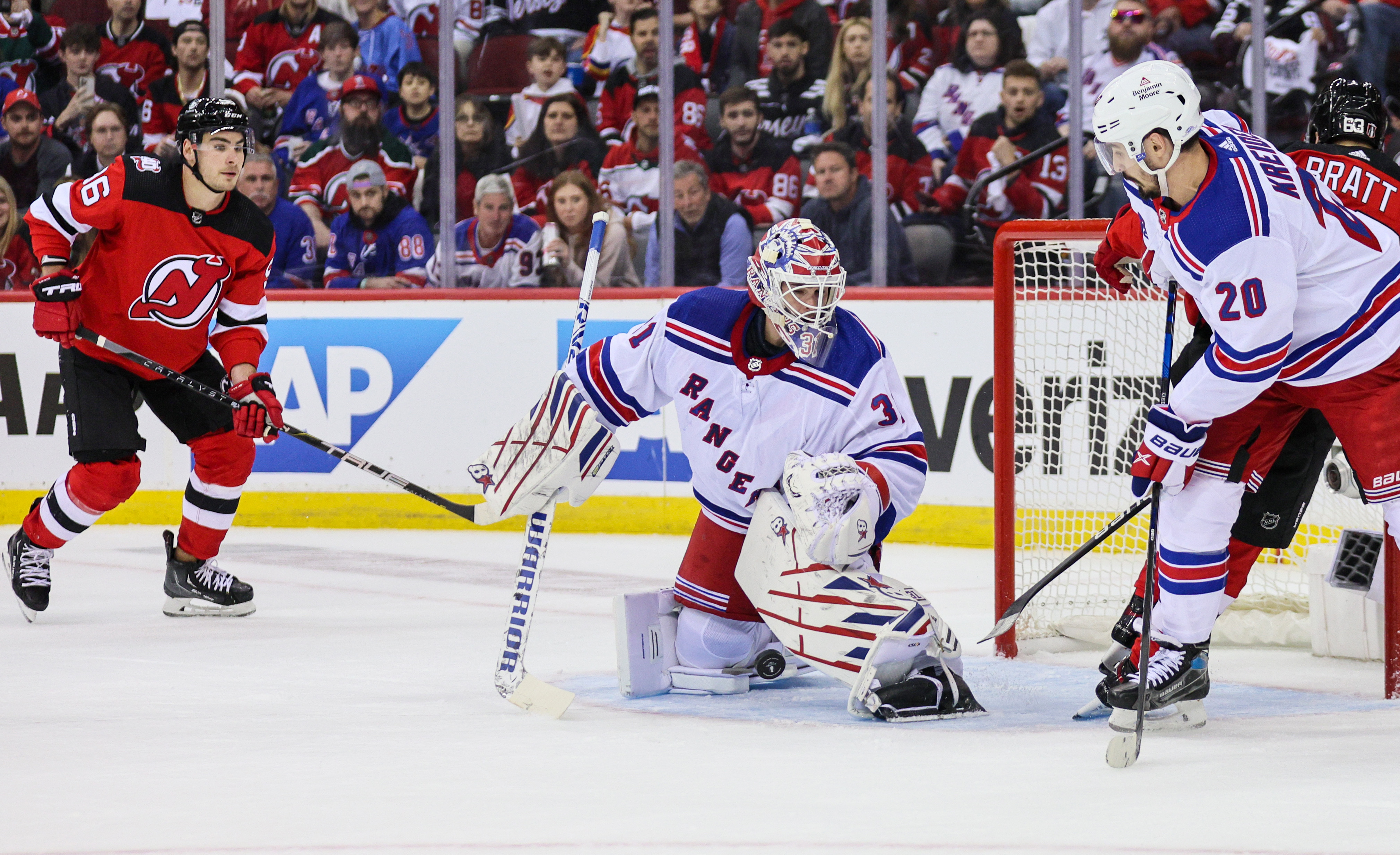 The puck bounces between the legs of New York Rangers goaltender Igor Shesterkin (31) as New Jersey Devils right wing Timo Meier (96, left) looks for a rebound during the first period on Tuesday, April 18, 2023 in Newark, N.J. The Rangers won, 5-1.