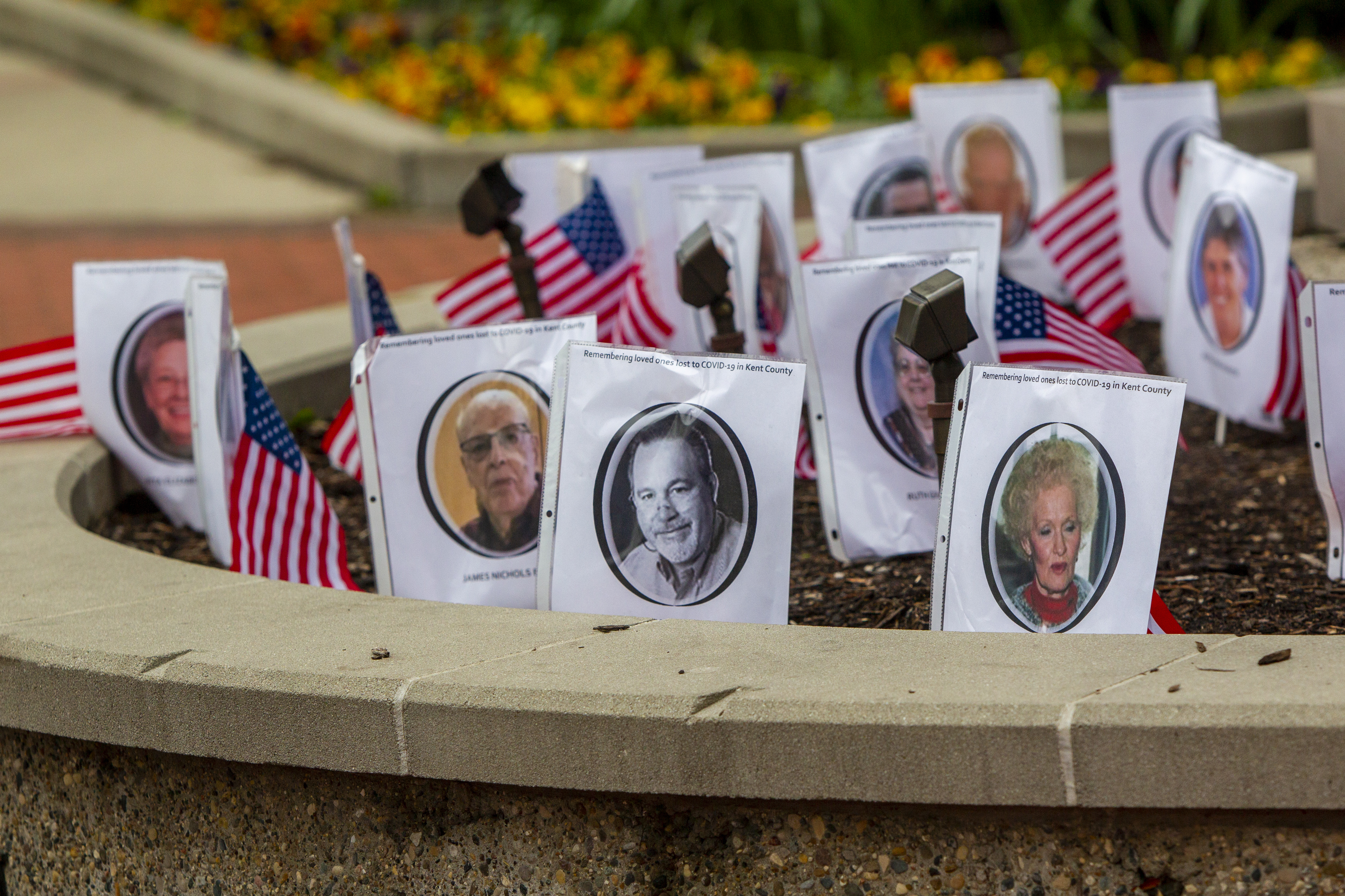 Part of Karen Dunnam's memorial to coronavirus victims set up as a counter-protest across the street from the "American Patriot Rally-Sheriffs speak out" event at Rosa Parks Circle in downtown Grand Rapids on Monday, May 18, 2020. The crowd is protesting against Gov. Gretchen Whitmer's stay-at-home order. (Cory Morse | MLive.com)