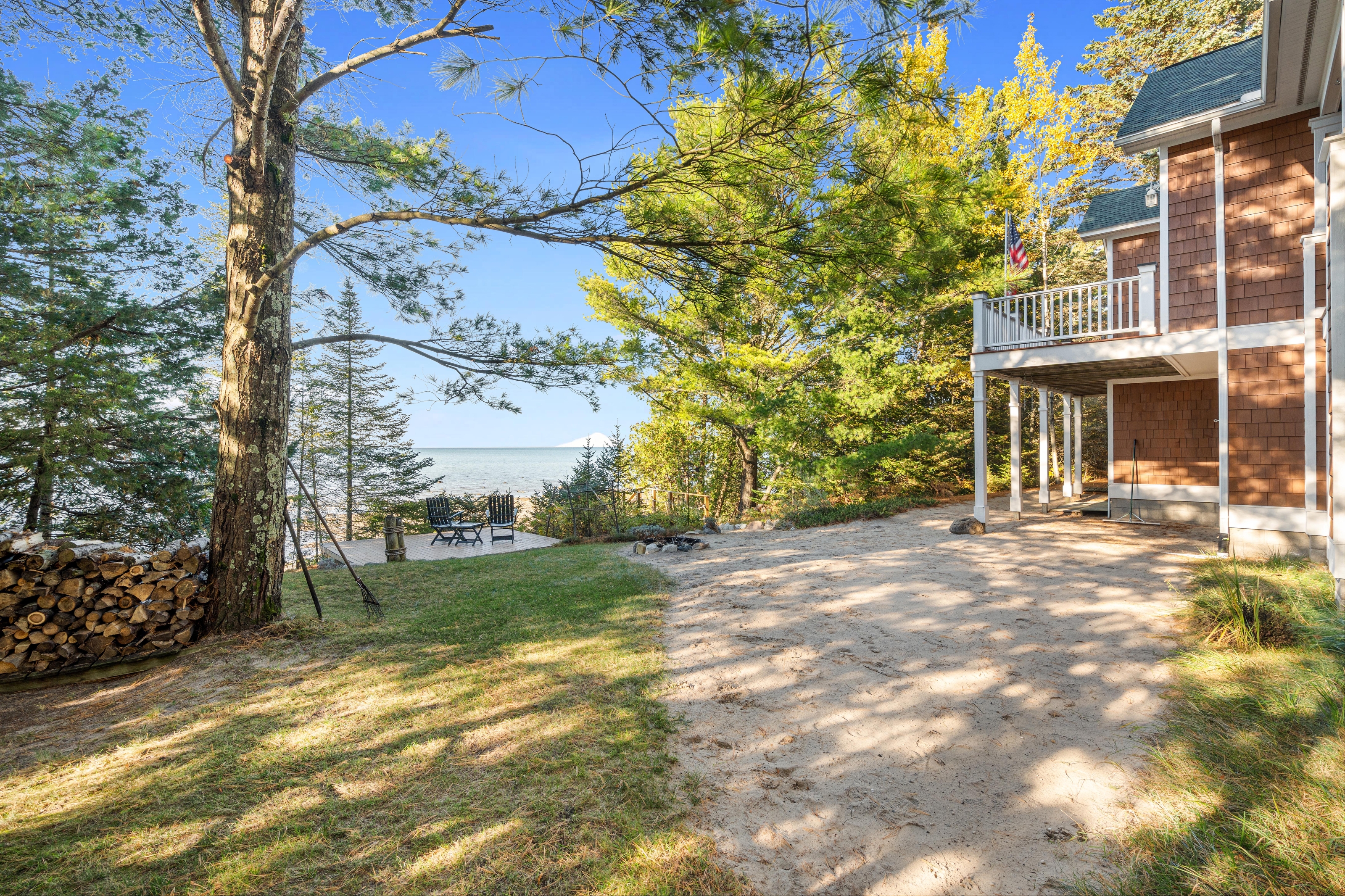 Exterior photographs of 4093 Lake Shore Drive in Charlevoix, this gem is listed at $2,099,900 through Berkshire Hathaway HomeServices Michigan Real Estate – Traverse City and The Crane Group with associate broker Johnny Crane and his brother, co-listing agent Matt Crane.