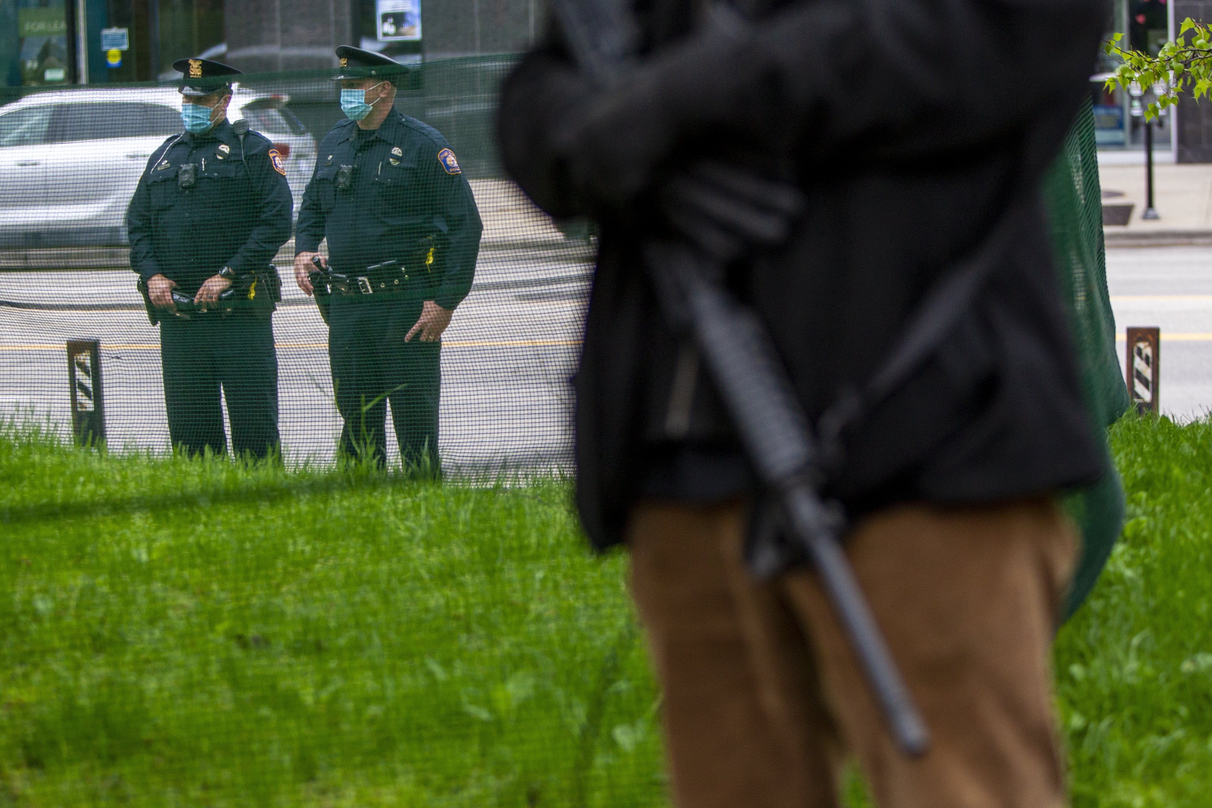 Law enforcement watches as a crowd gathers for the "American Patriot Rally-Sheriffs speak out" event at Rosa Parks Circle in downtown Grand Rapids on Monday, May 18, 2020. The crowd is protesting against Gov. Gretchen Whitmer's stay-at-home order. (Cory Morse | MLive.com)