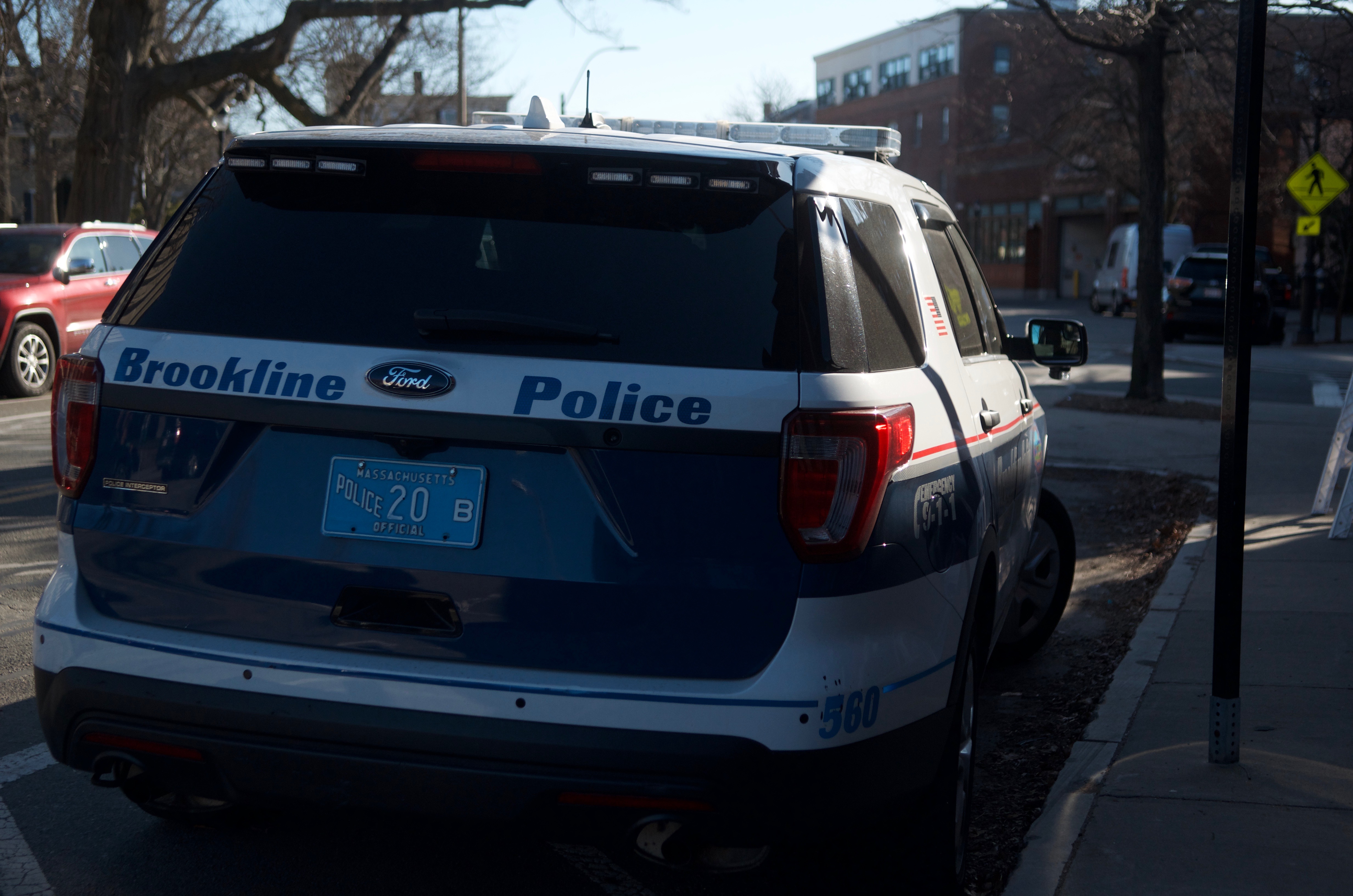 Brookline Police lead Zanini Cineus into Brookline Municipal Court