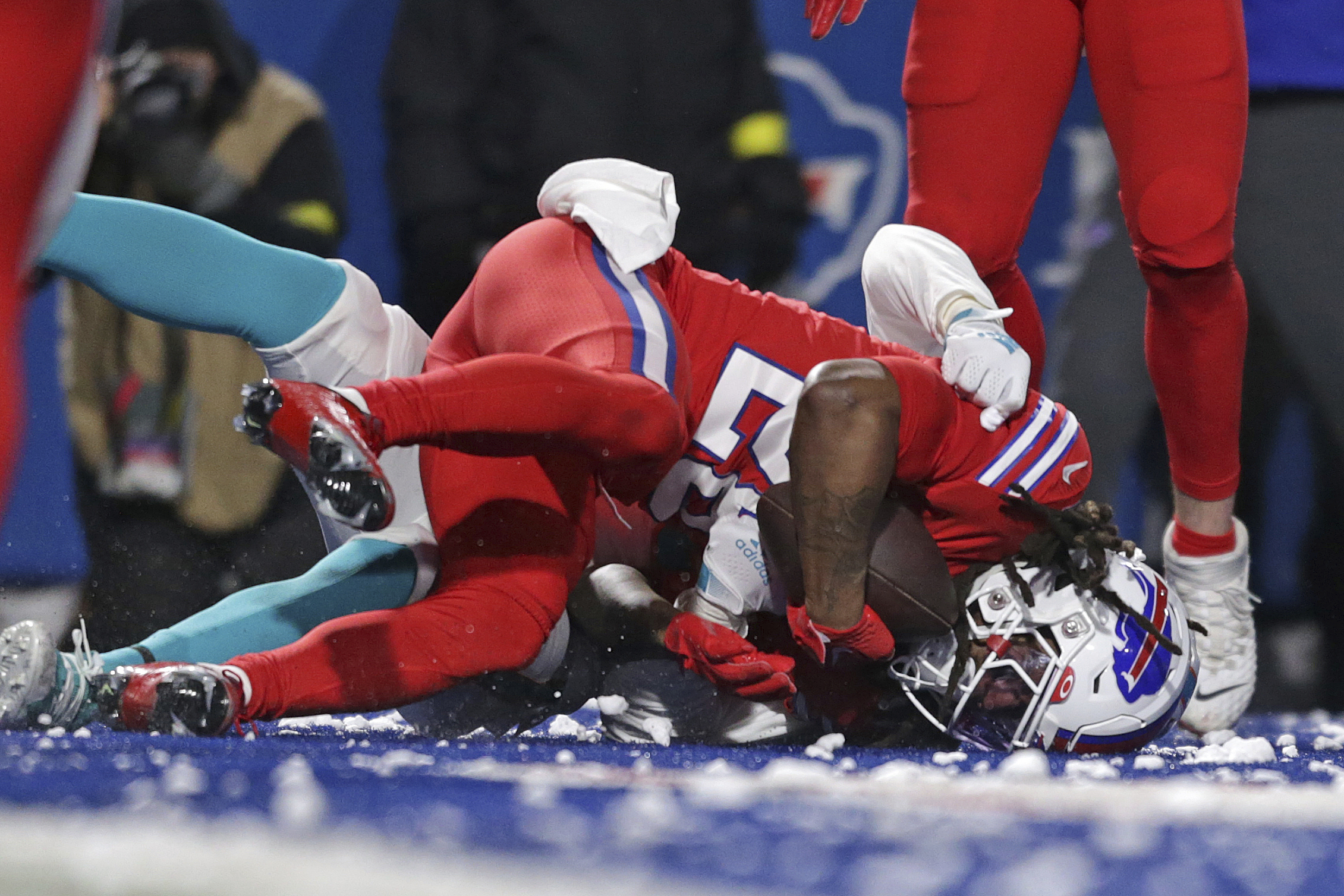 Miami Dolphins wide receiver Jaylen Waddle (17) catches a pass Buffalo Bills  cornerback Tre'Davious White (27) during second quarter of an NFL football  game at Highmark Stadium on Saturday, Dec. 17, 2022