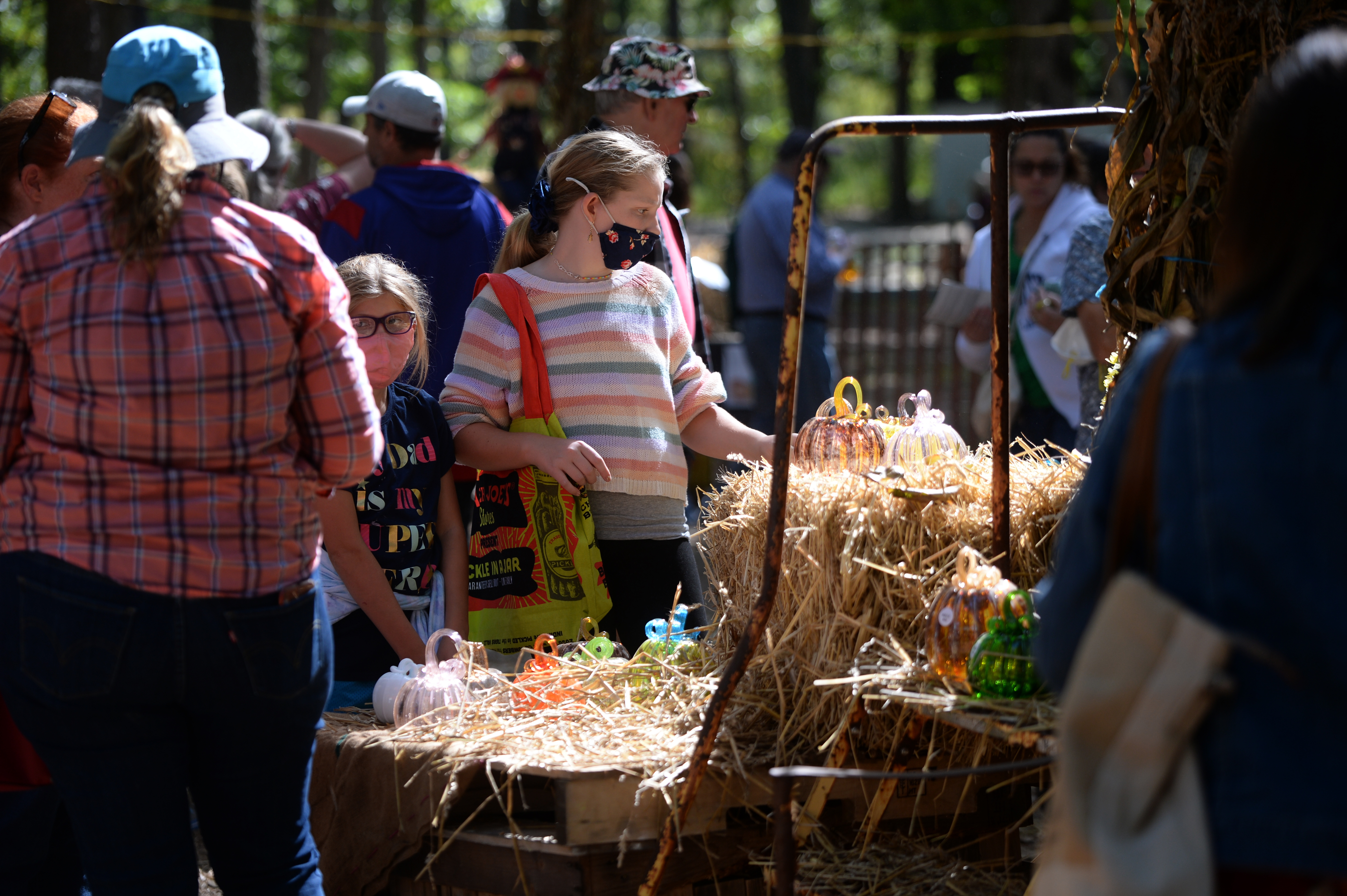 Customers browse the glass pumpkin patch during the 22nd annual Festival of Fine Craft at Wheaton Arts in Millville, Saturday, Oct. 2, 2021.
