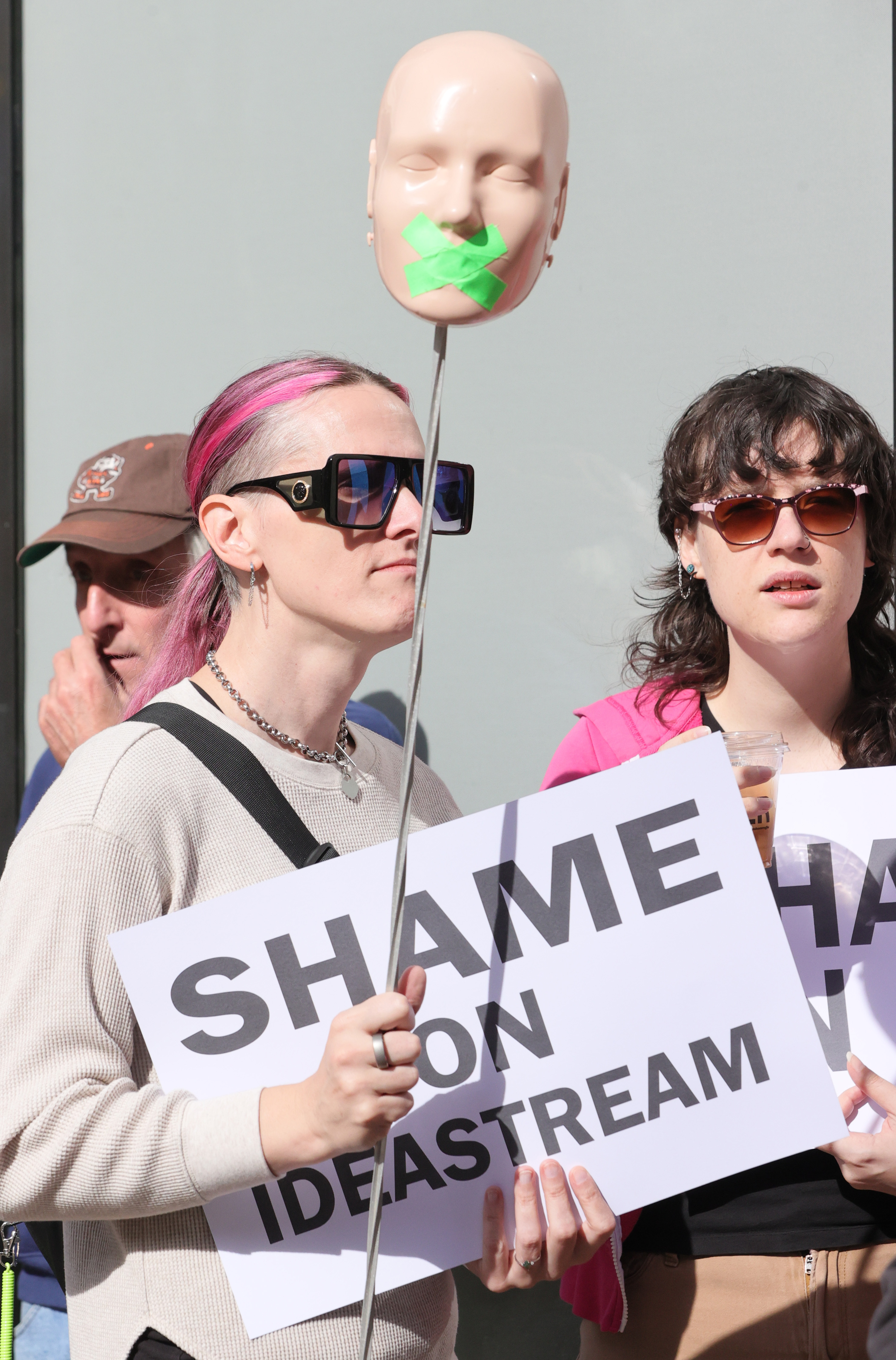 Protestors rally outside Cleveland’s City Club during lunch forum with ...