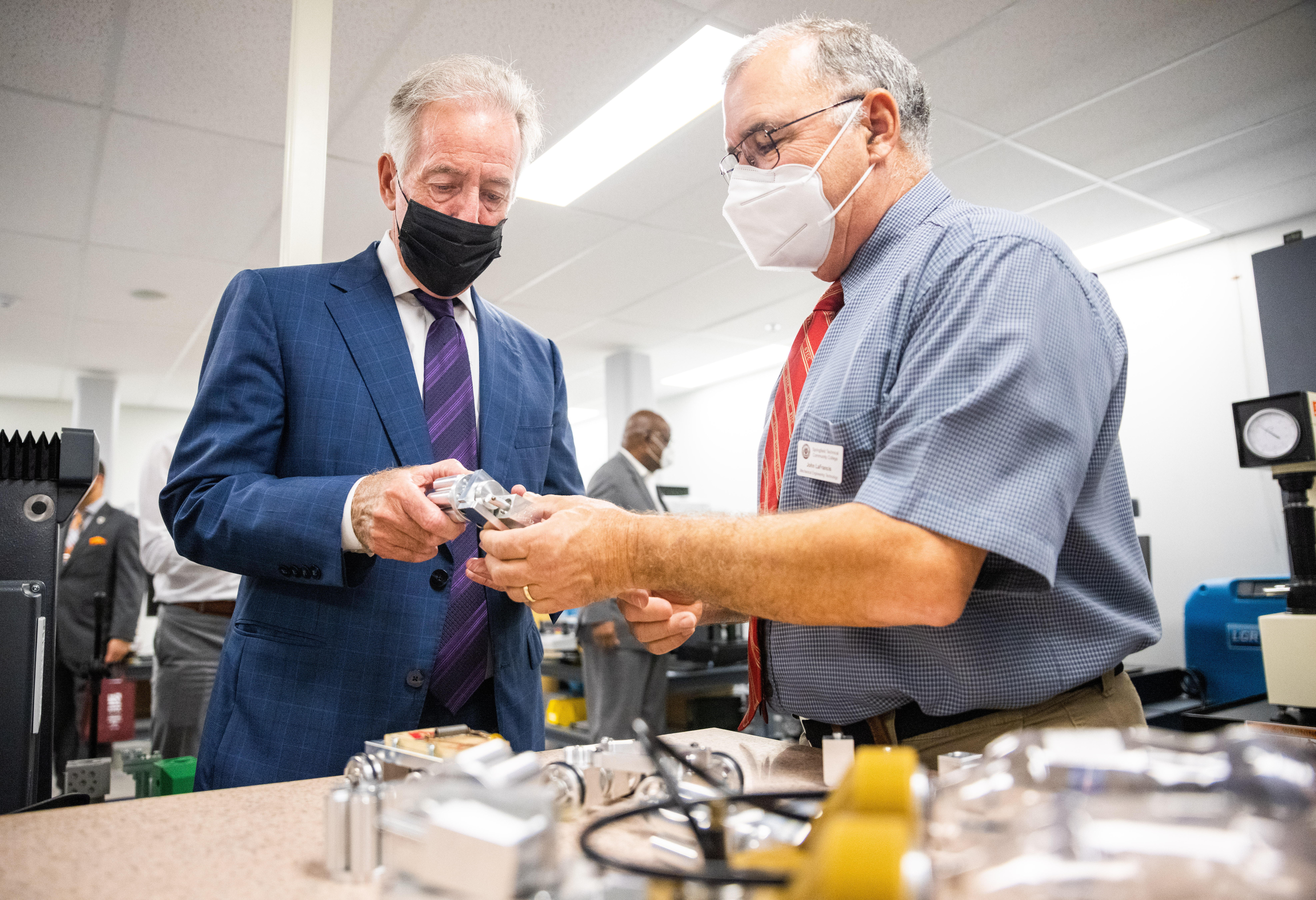 John LaFrancis, Mechanical Engineering Technology professor at Springfield Technical Community College, right, shows parts manufactured at the college's shop to U.S. Rep Richard E. Neal, left, during a tour on Thursday, Oct. 6, 2021. (Hoang ‘Leon’ Nguyen / The Republican)
