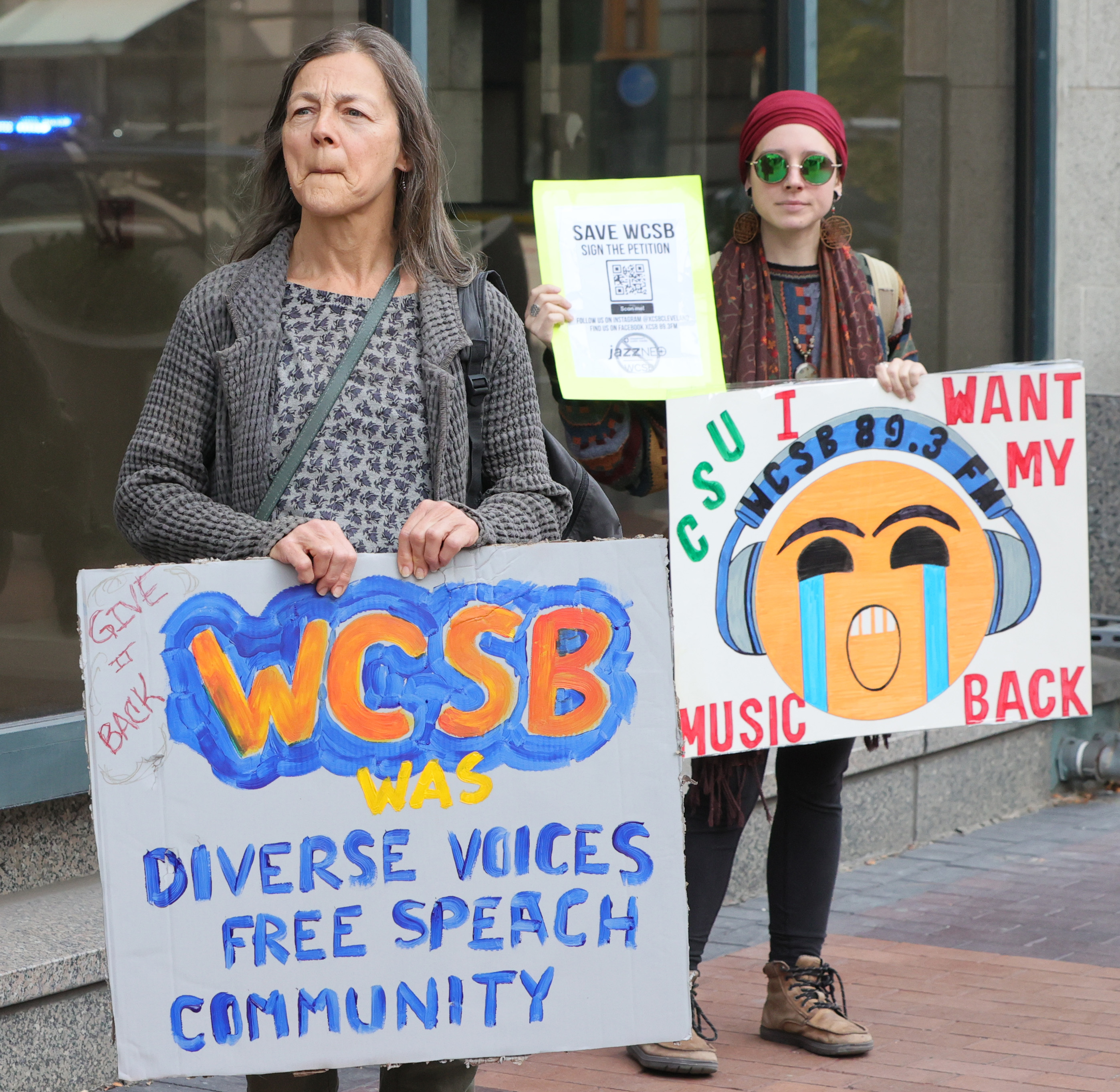 Protestors rally outside Cleveland’s City Club during lunch forum with ...