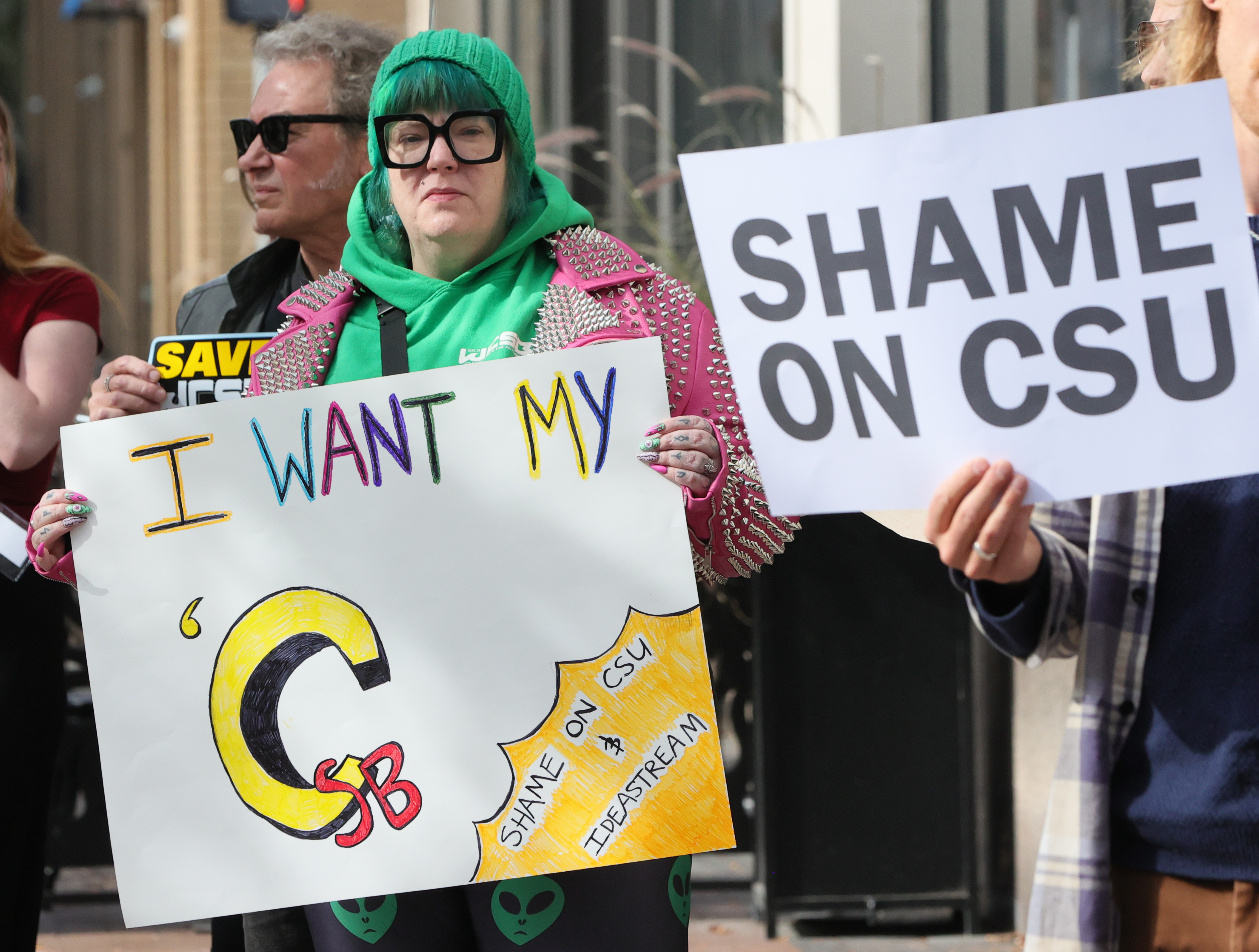 Protestors rally outside Cleveland’s City Club during lunch forum with ...