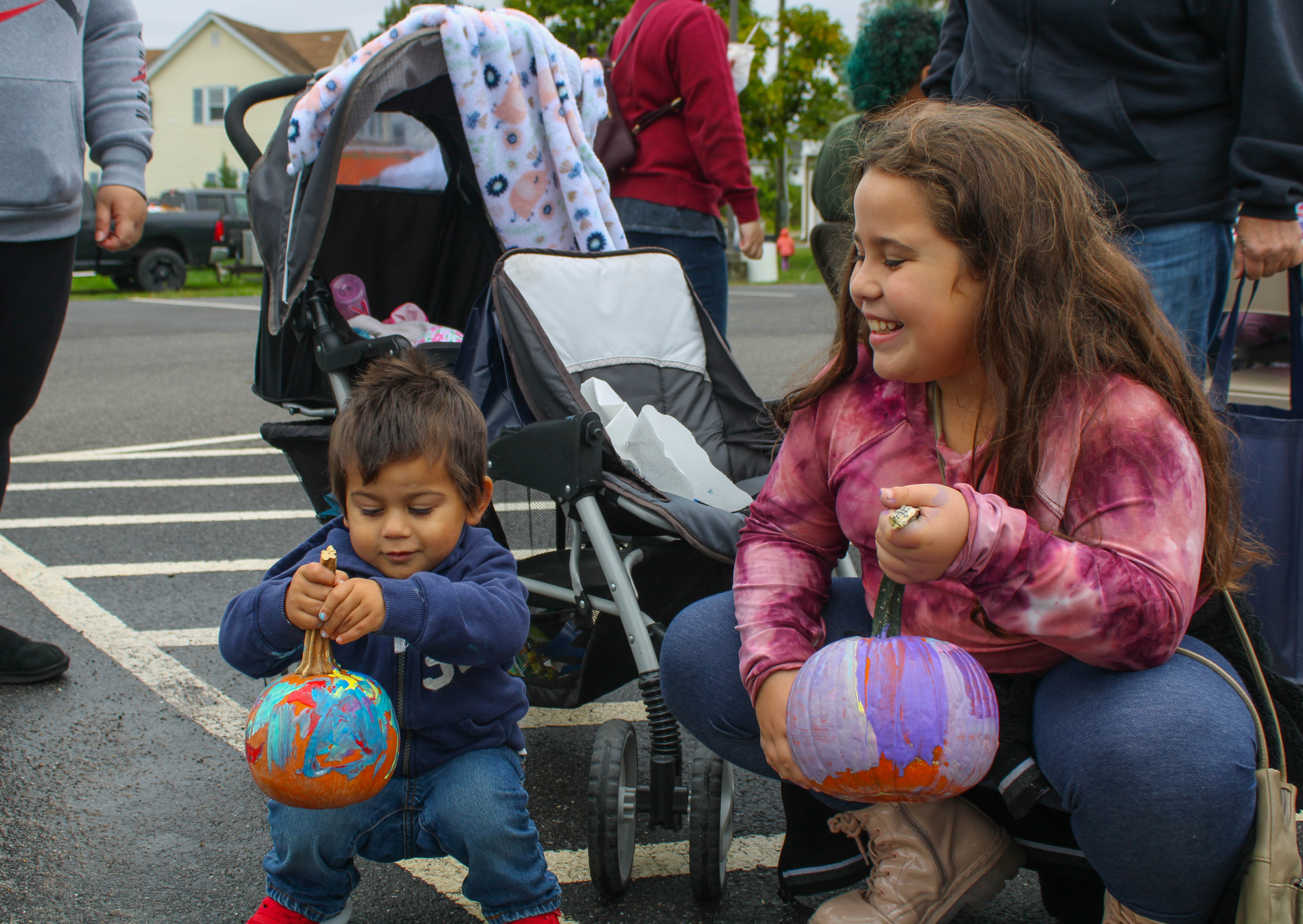 Keanu, 2, and Marlie Hernandez, 8, present their freshly painted pumpkins at the Harvest Day Festival in Elmer, Saturday, Oct. 1, 2022.