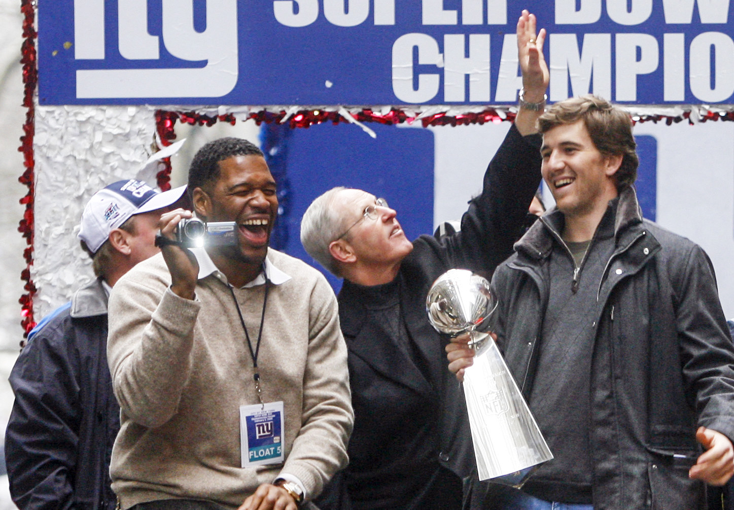 Michael Strahan (left) Coach Tom Coughlin, Eli Manning, Jerry Reese II and his father, Giants GM Jerry Reese celebrate with the Vince Lombardi Trophy as New York City celebrates the New York Giants win in Super Bowl XLII with a ticker tape parade up Broadway.  MANHATTAN, NYC (2008 file photo by Andrew Mills | The Star-Ledger)