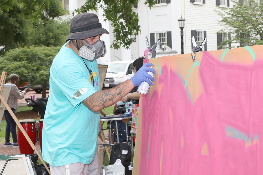 Artist Rich Nice works on his artwork at Chalk for Change 2022 taking place at Court Square in Springfield on July 16th. (Ed Cohen Photo)