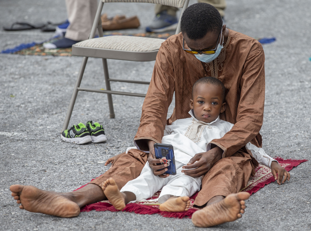 Yussif Abdul and his son Rayyan Yussif wait for prayers to begin outside the Islamic Center Masjid Al-Sabereen in Harrisburg, Pa., during prayer celebration of the muslim holiday of Eid Al-Adha, July 31, 2020.
Mark Pynes | mpynes@pennlive.com