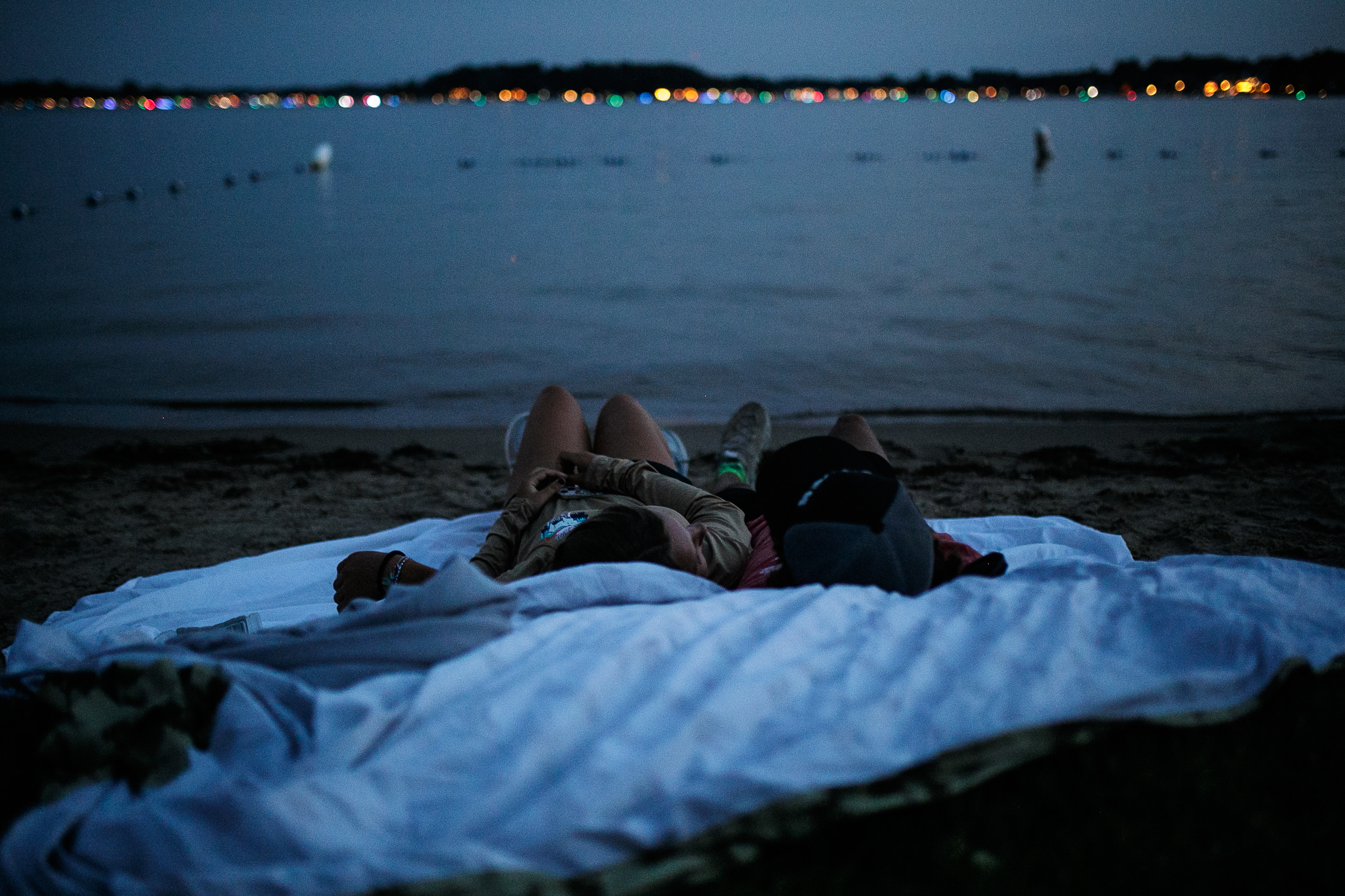 A couple rests on a blanket while waiting in anticipation of  the annual Lake Fenton Fireworks on the water in front of the Township hall on Saturday, June 2, 2022 in Fenton Township. (Jenifer Veloso | MLive.com)


