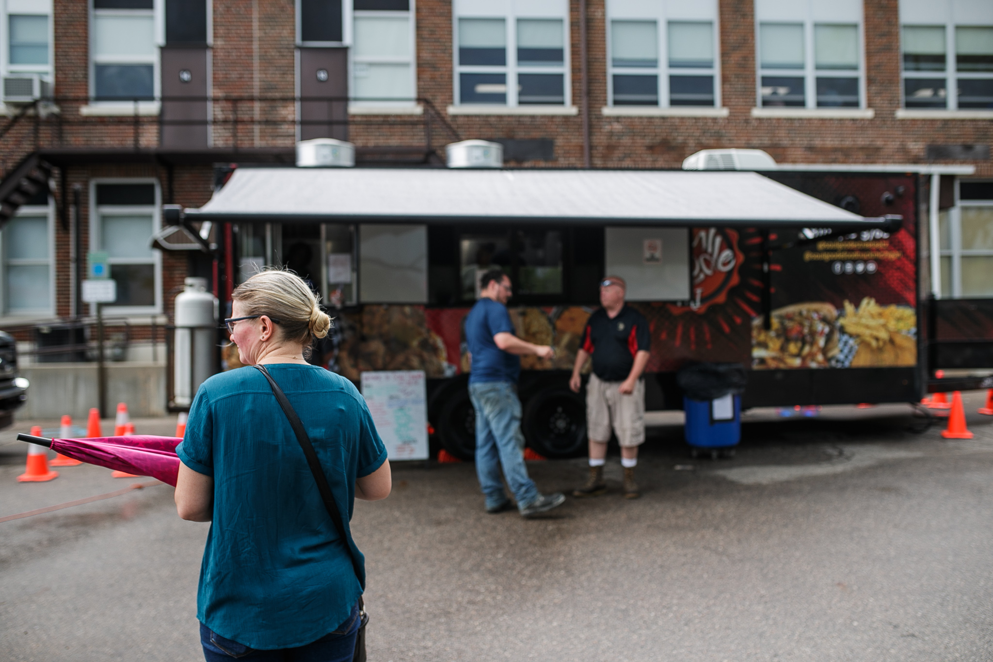 Attendants wait in line next to multiple food trucks during the Perry Center Centennial Event in Grand Blanc on Saturday, May 14, 2022. (Jenifer Veloso | MLive.com)