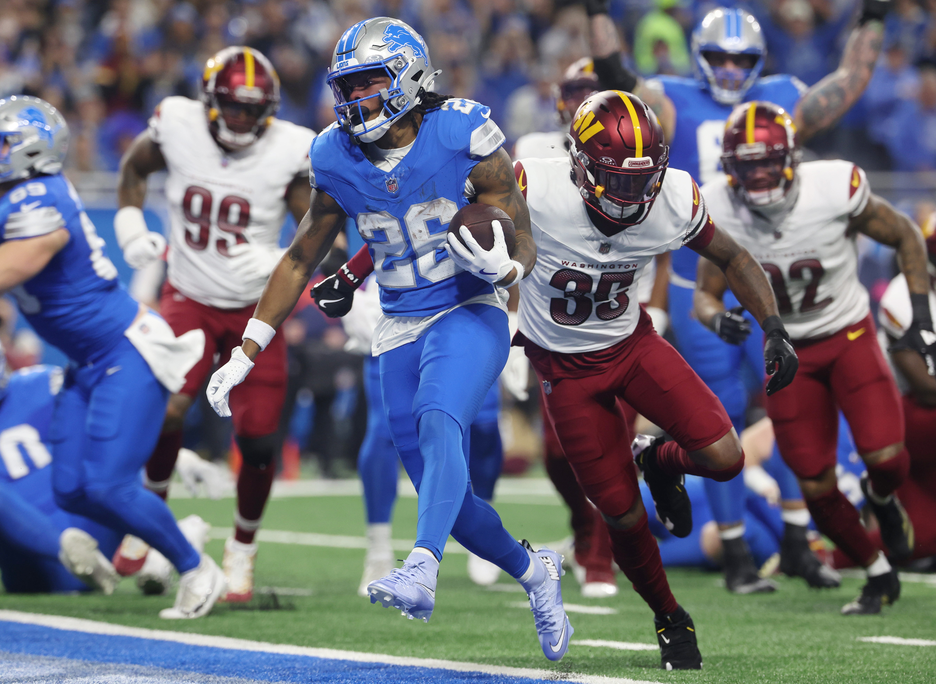 Detroit Lions running back Jahmyr Gibbs (26) runs the ball for a touchdown during the first half of an NFL football divisional playoff game, Saturday, Jan. 18, 2025, in Detroit. 