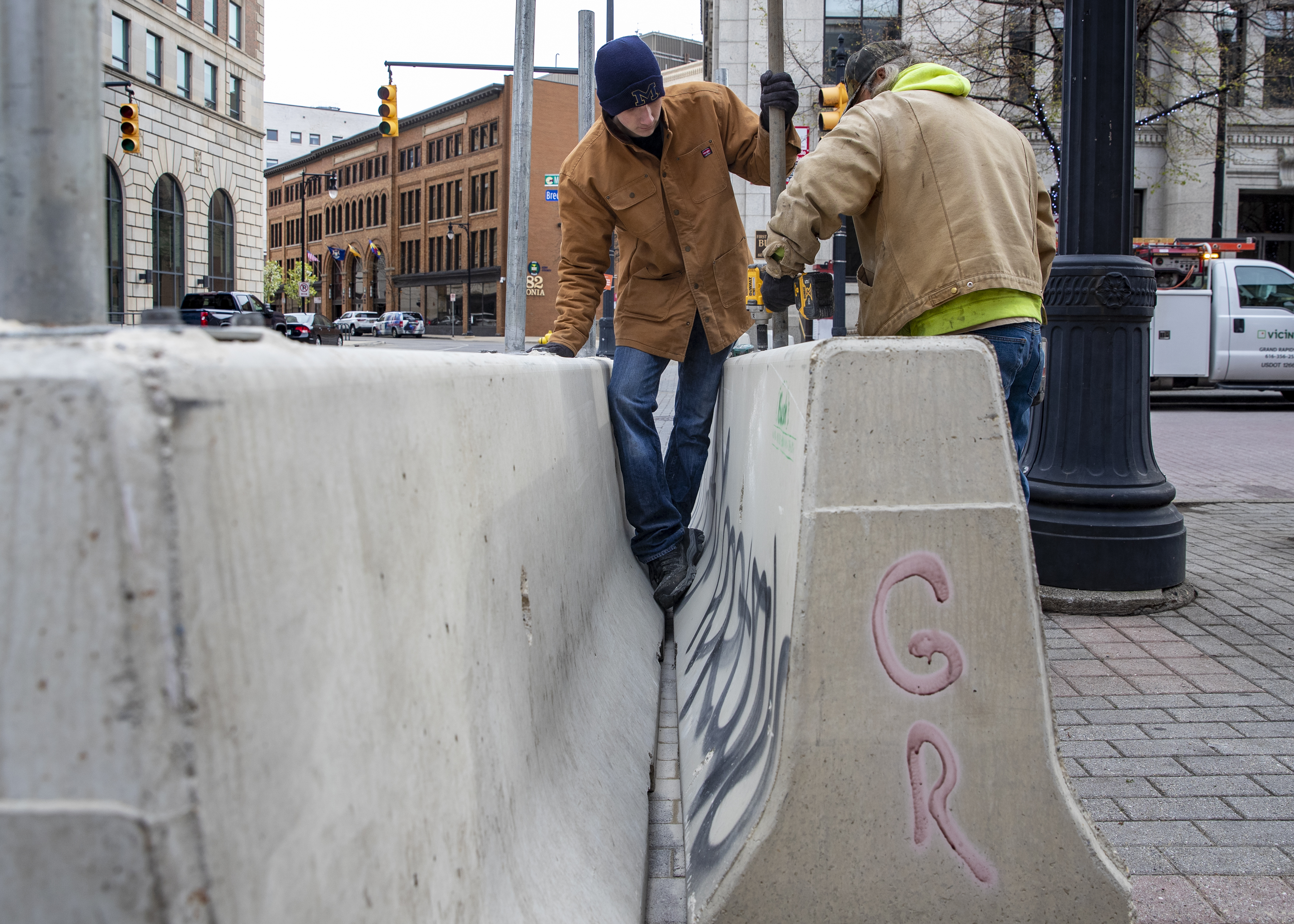 Cole Bond, left, and Mike Jack, from Fence Consultants of West Michigan, put up barricades in downtown Grand Rapids on Tuesday, April 20, 2021, as a jury deliberates fate of Derek Chauvin in death of George Floyd. A riot on May 30, 2020, caused significant property damage in the aftermath of a peaceful protest following the death of Floyd in Minneapolis. (Cory Morse | MLive.com)