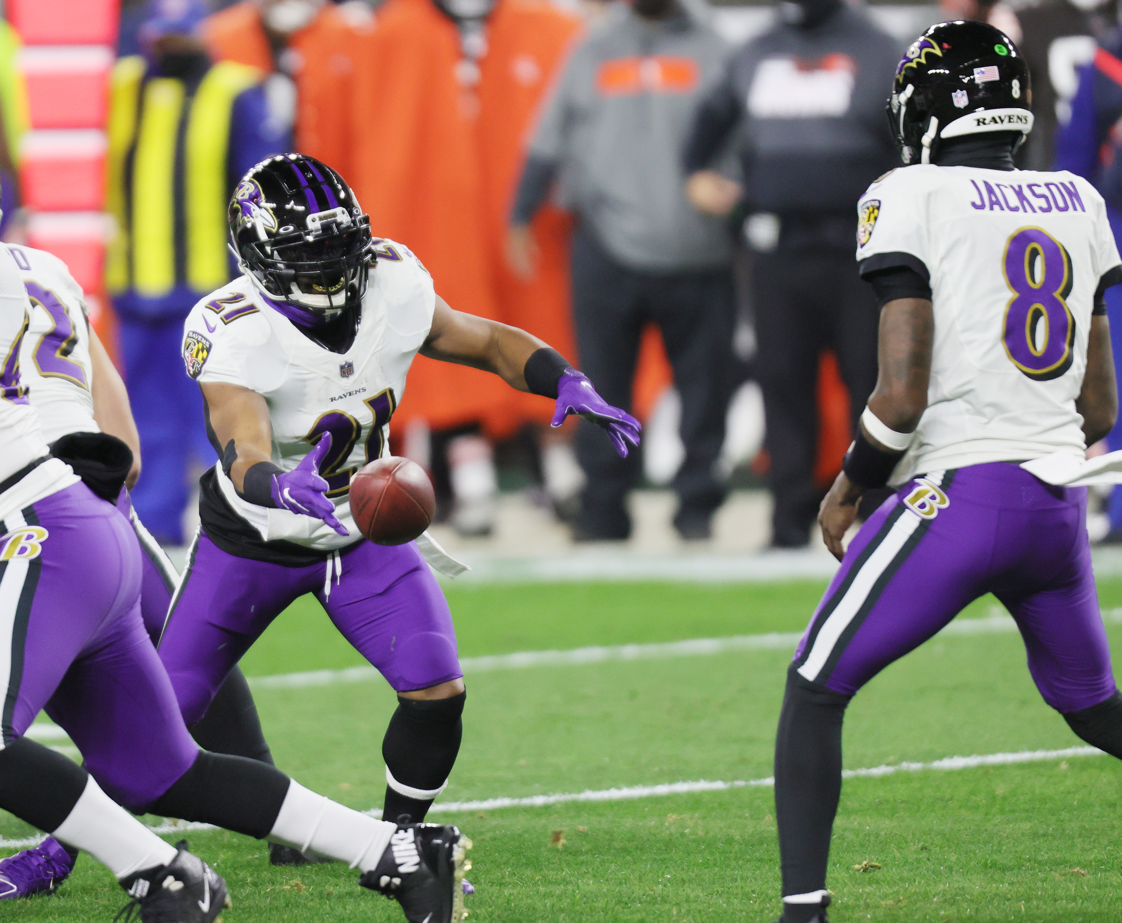 Baltimore Ravens running back J.K. Dobbins (27) takes a handoff from  quarterback Lamar Jackson …