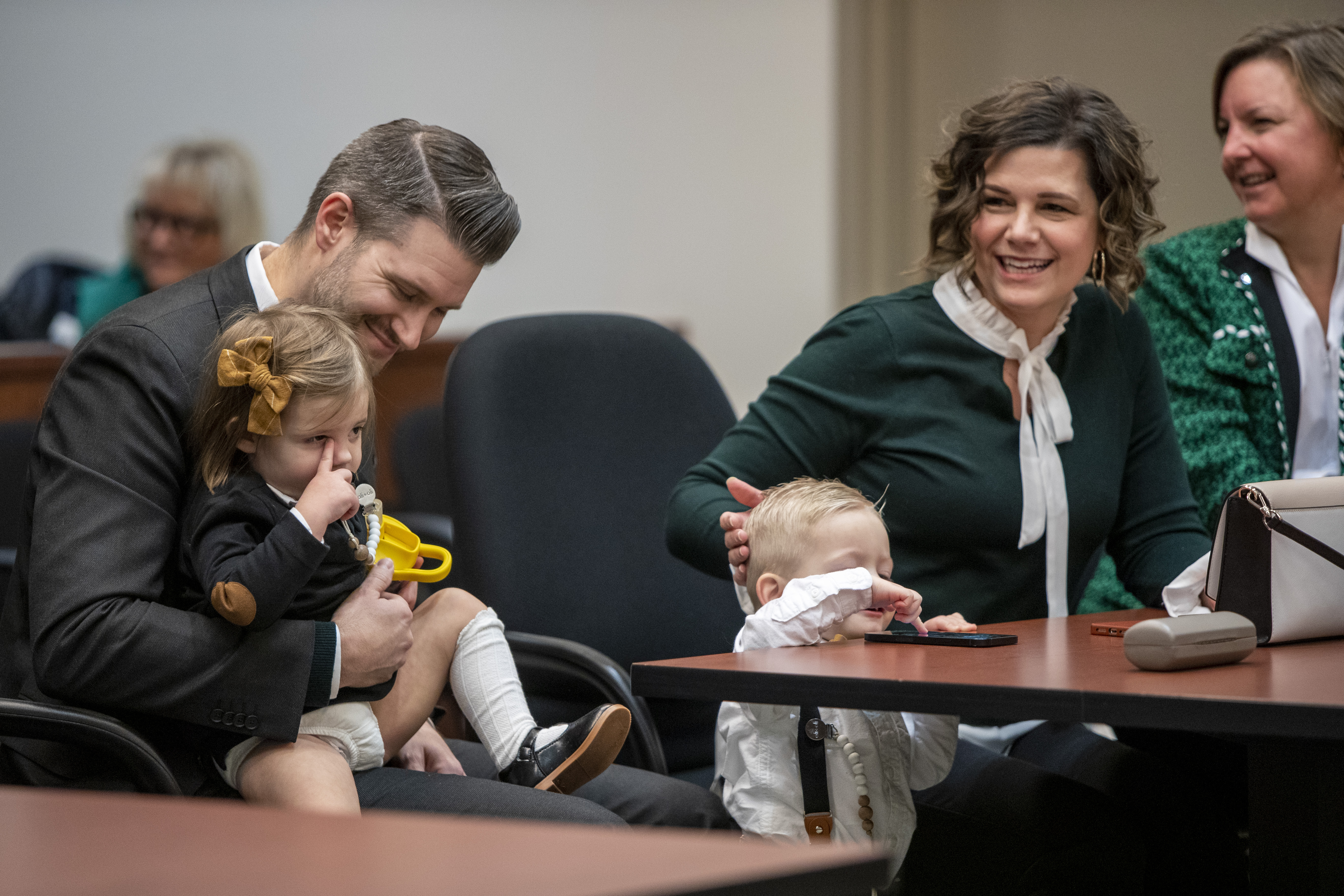 Tammy and Jordan Myers hold their twins, Ellison, left, and Eames, during Adoption Day at the Kent County Courthouse in Grand Rapids on Thursday, Dec. 8, 2022.  Tammy and Jordan are the biological parents of the 1-year-old twins. Lauren Vermilye, a surrogate, gave birth to the twins after Tammy went through breast cancer treatment and has no claim to the babies. The Myers family was able to adopt the twins after convincing the court system to grant them custody. (Cory Morse | MLive.com)