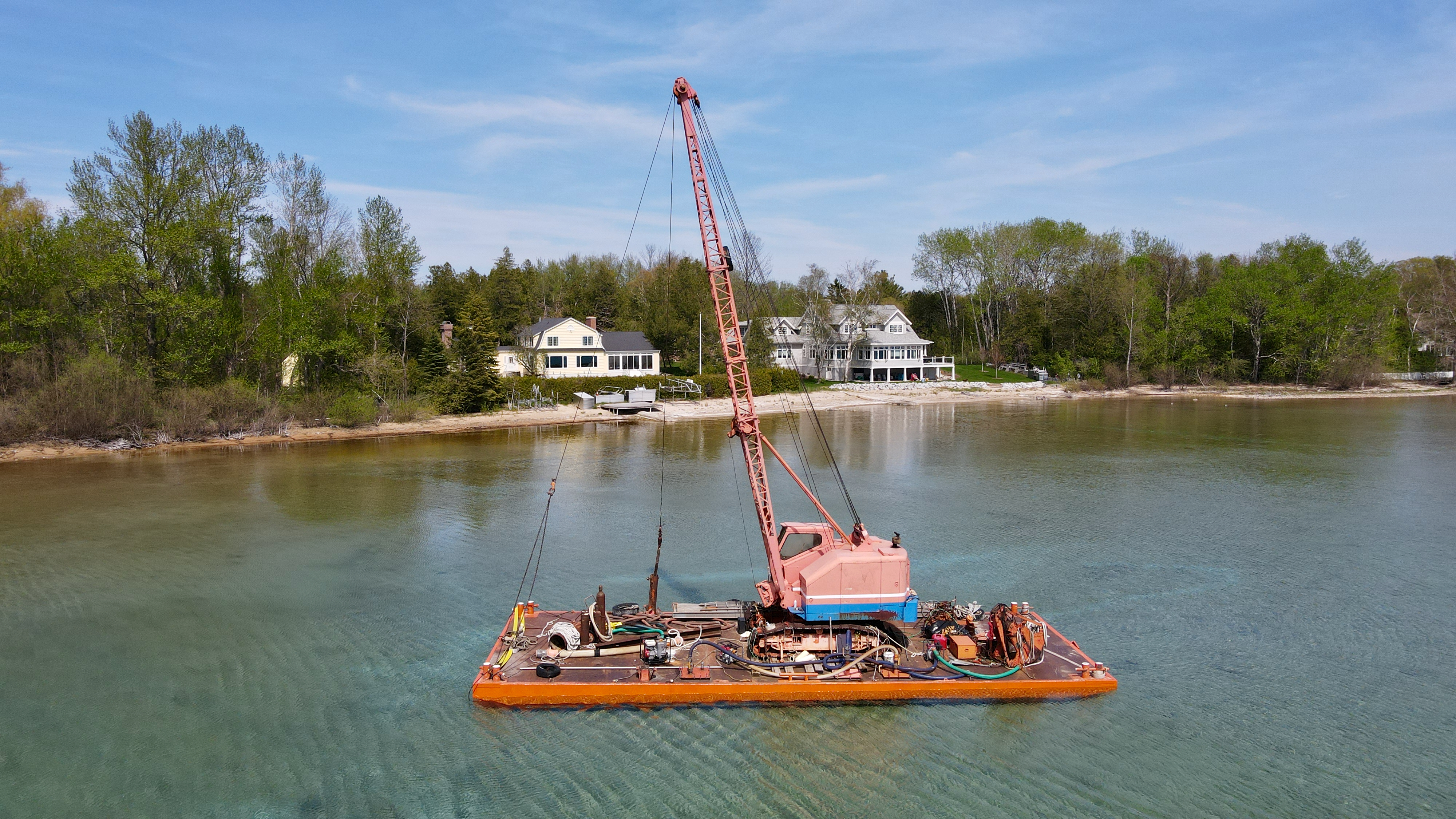 A Balcom Marine Contracting barge in West Grand Traverse Bay’s Hall Bay near Northport, Mich., May 13, 2023. The barge is notorious for sinking in various spots around the area. On June 22, Michigan Attorney General Dana Nessel charged owner Donald Balcom of Traverse City with a felony related to oil releases from the barge and other misdemeanors. (Garret Ellison | MLive) 