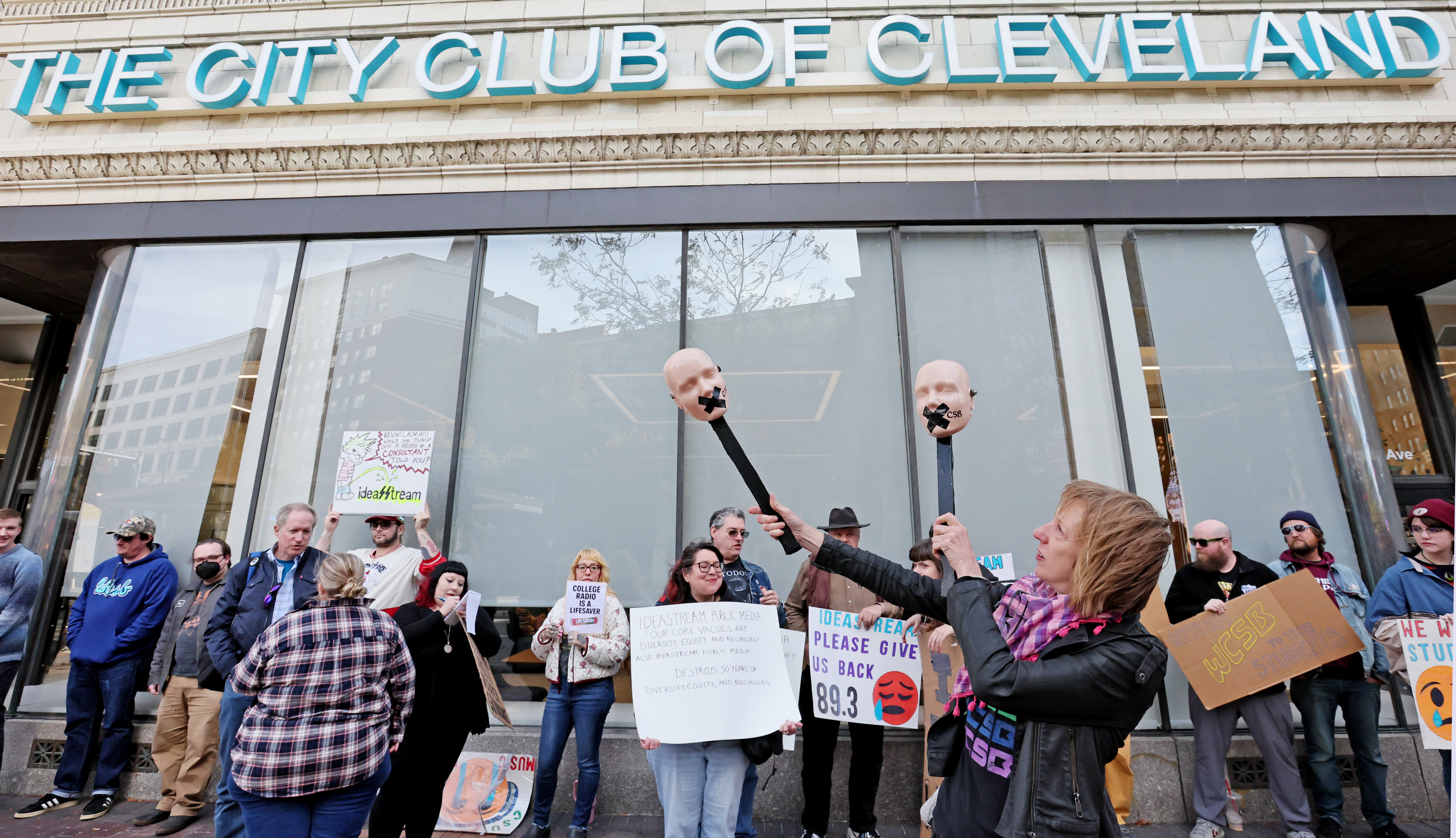 Protestors rally outside Cleveland’s City Club during lunch forum with ...