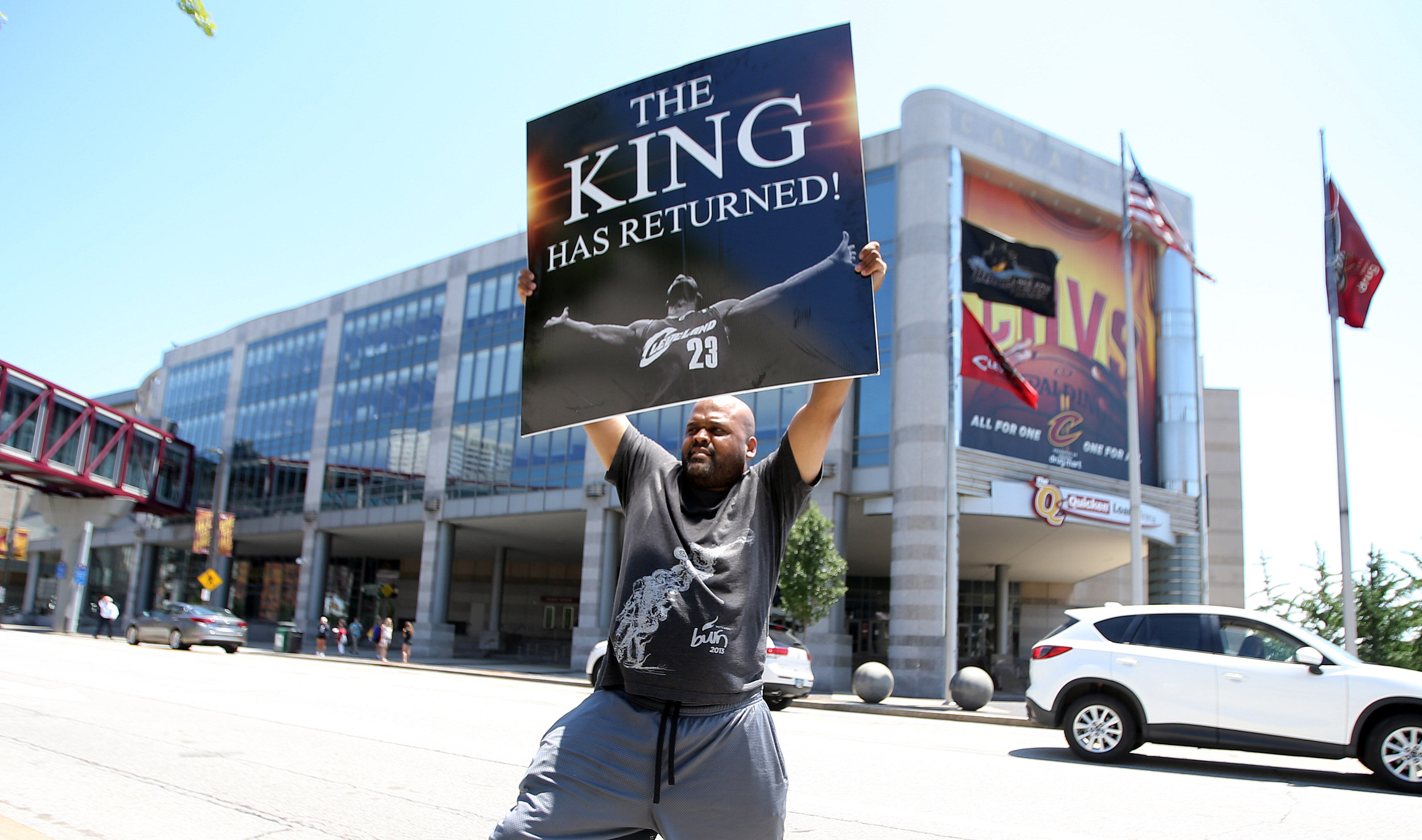 Alvin Smith, a graphic designer from Cleveland, holds up a sign he made shortly after LeBron James announced his return to Cleveland Friday, July 11, 2014, outside of Quicken Loans Arena in Cleveland. Smith made the sign two days ago in hopes that LeBron would return home.  (Joshua Gunter/ The Plain Dealer) 