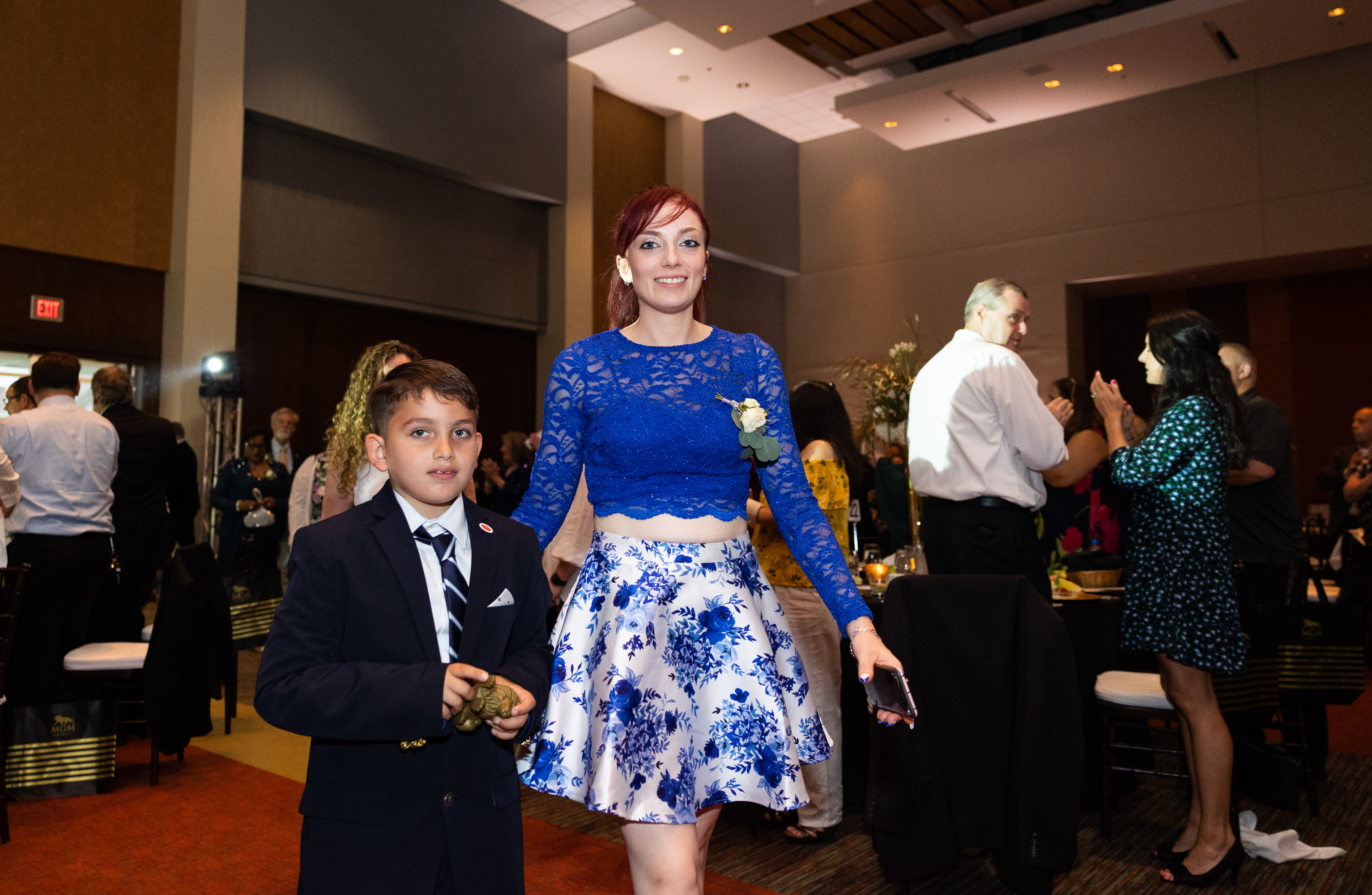 Finalist Felicia Laurin, of Inn on Boltwood, walks to the stage with her son Daniel at the 25th annual Howdy Awards for Hospitality Excellence held at the MassMutual Center Monday evening, May 16, 2022. (Hoang ‘Leon’ Nguyen / The Republican)