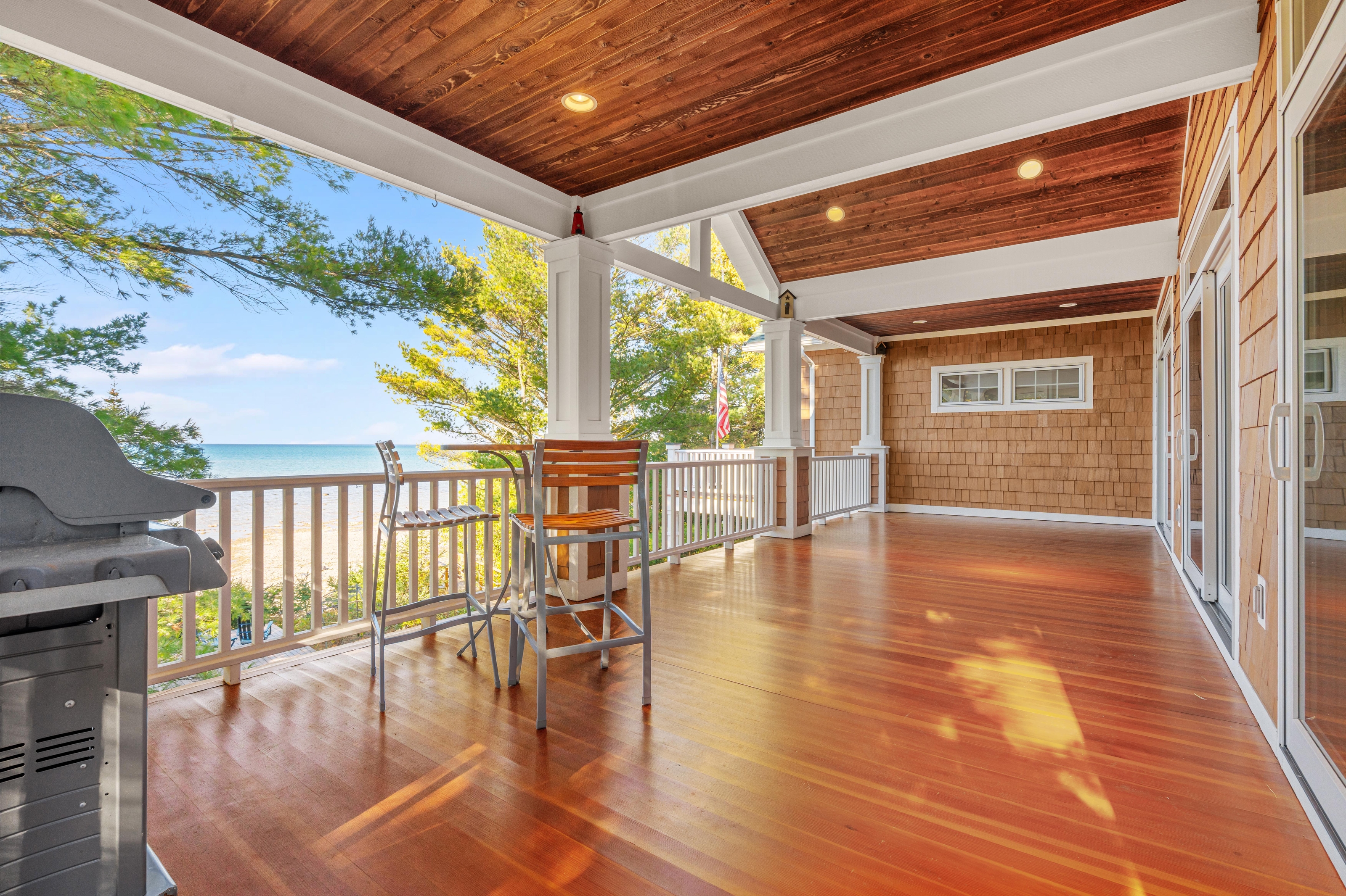 Exterior photographs of 4093 Lake Shore Drive in Charlevoix, this gem is listed at $2,099,900 through Berkshire Hathaway HomeServices Michigan Real Estate – Traverse City and The Crane Group with associate broker Johnny Crane and his brother, co-listing agent Matt Crane.