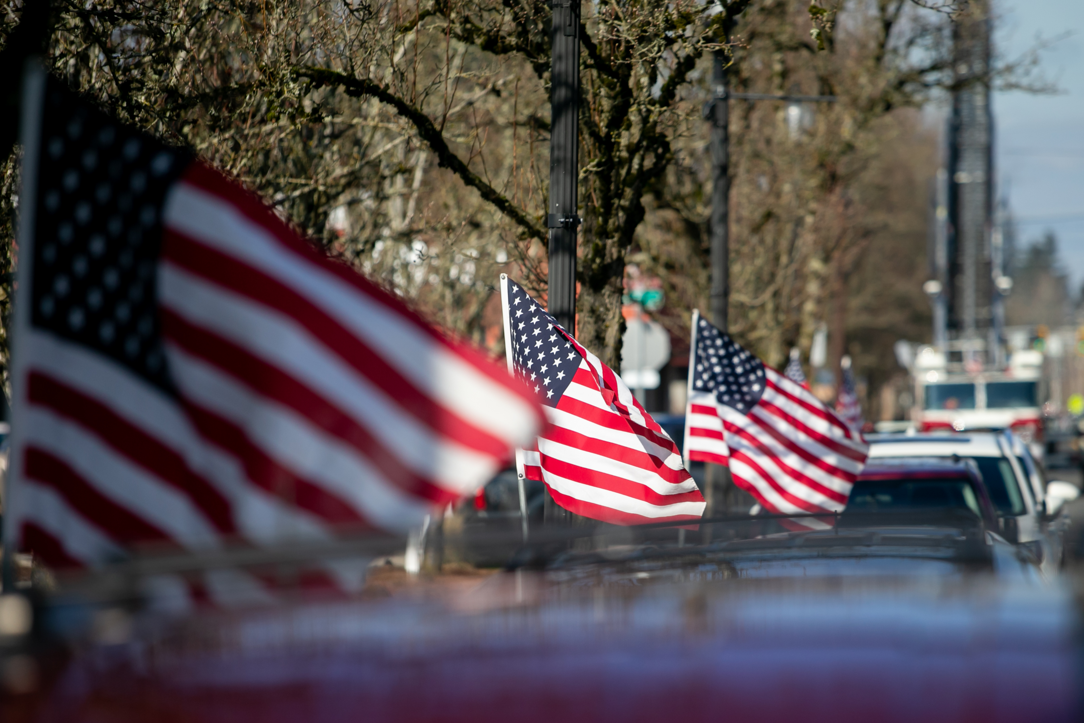 American flags line the streets of downtown Gresham, Oregon in honor of Gresham Firefighter Brandon Norbury on Wednesday, Feb. 15 2023.