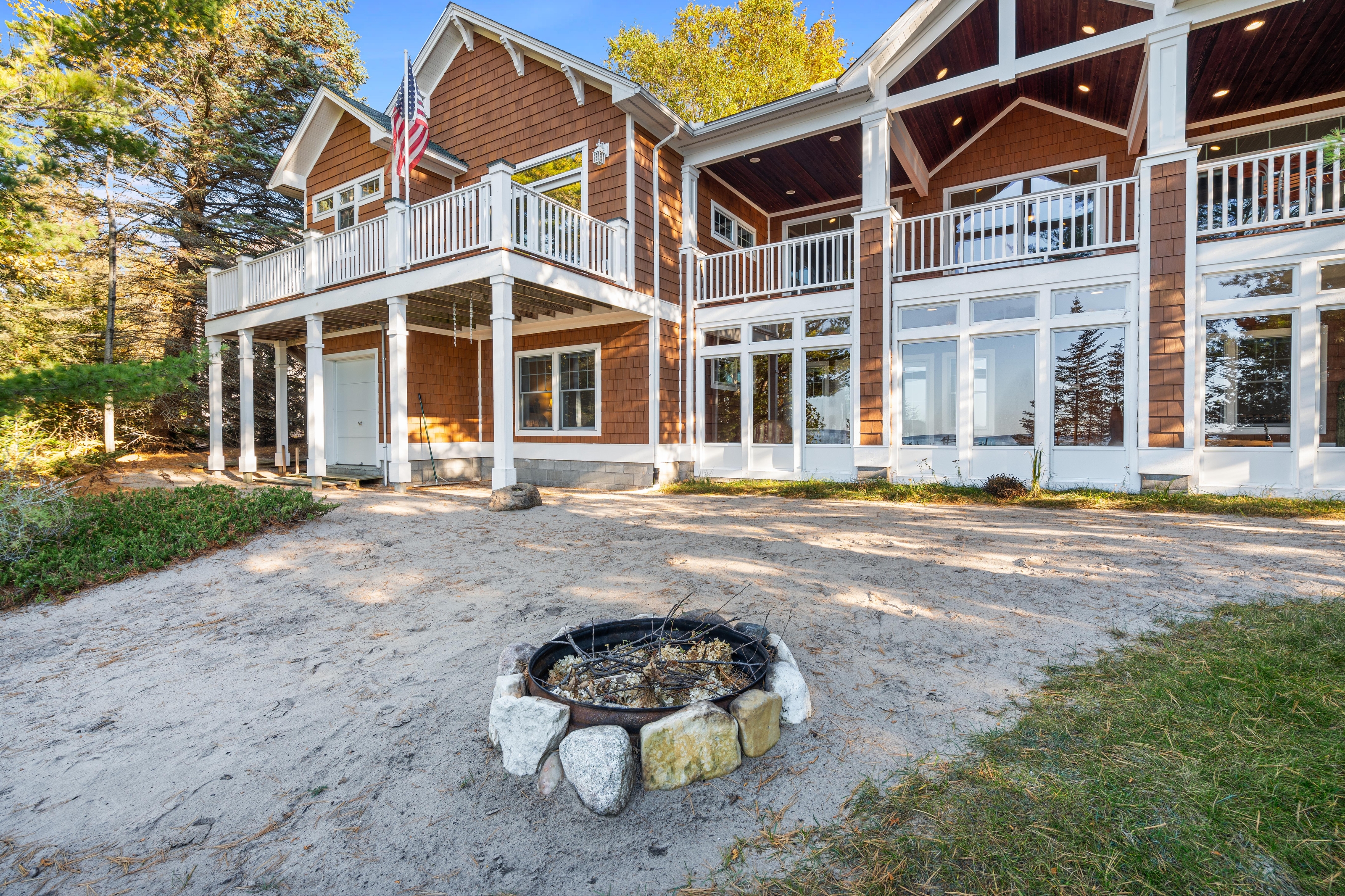 Exterior photographs of 4093 Lake Shore Drive in Charlevoix, this gem is listed at $2,099,900 through Berkshire Hathaway HomeServices Michigan Real Estate – Traverse City and The Crane Group with associate broker Johnny Crane and his brother, co-listing agent Matt Crane.