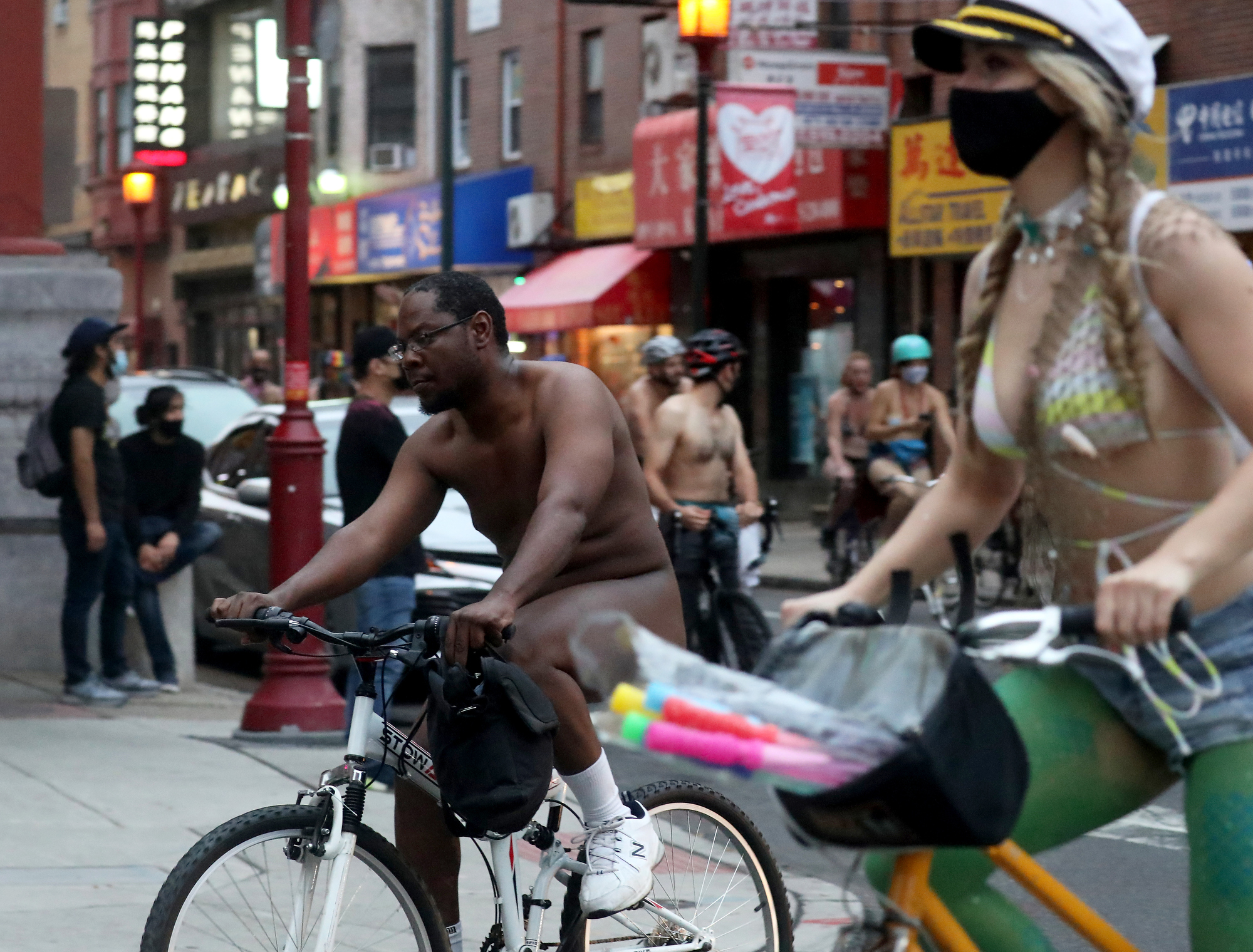 Philly Naked Bike Ride participants turn from 10th Street to Arch Street in Philadelphia, Saturday, Aug. 28, 2021.