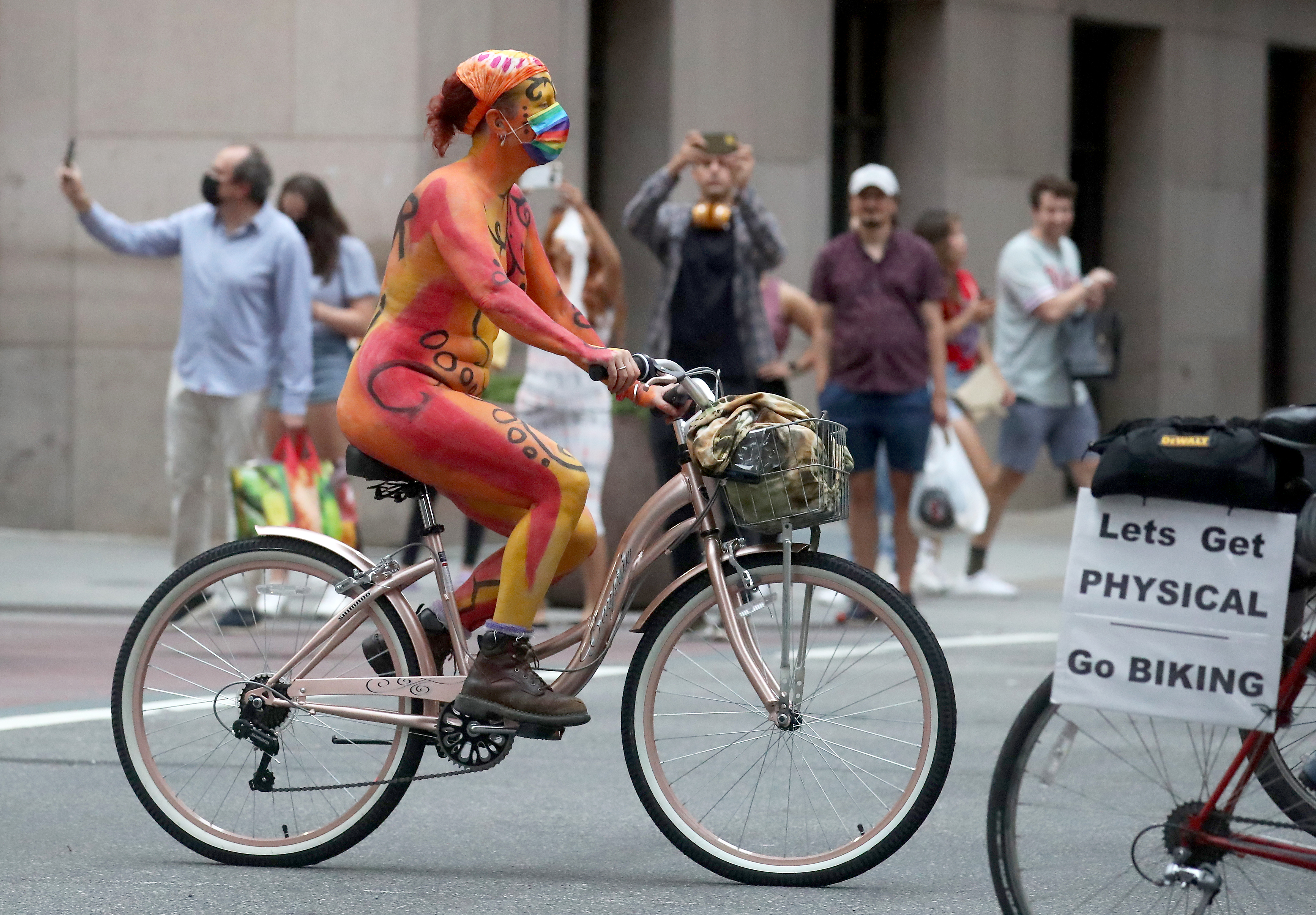 People ride bikes down South Broad Street in Philadelphia during the Philly Naked Bike Ride, Saturday, Aug. 28, 2021.