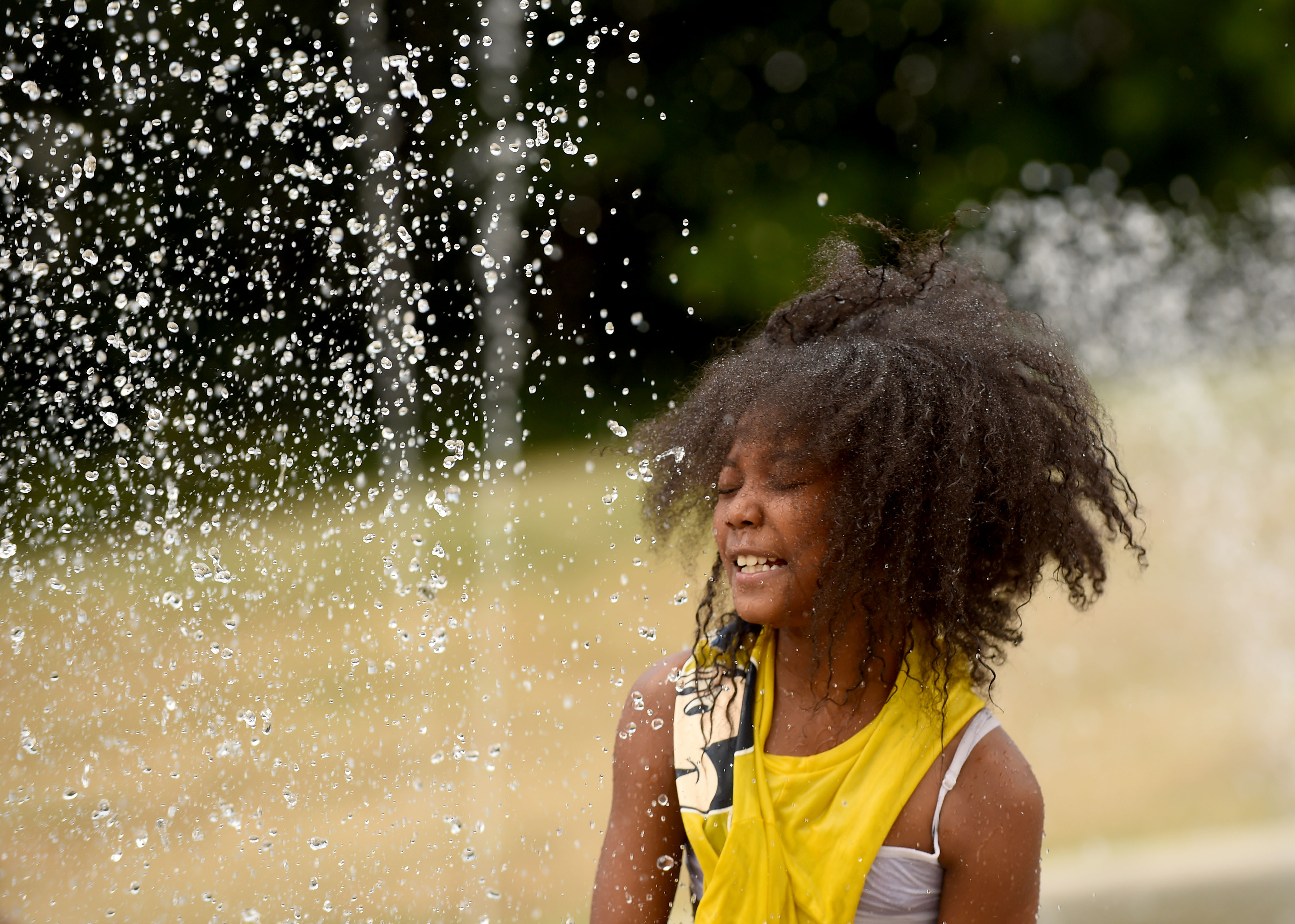 People are still looking for a way to cool down during a heat spell in Syracuse, July 8, 2020. Zayonna Crawford 10 yrs old  at the spray area at Onondaga Park.  Dennis Nett | dnett@syracuse.com