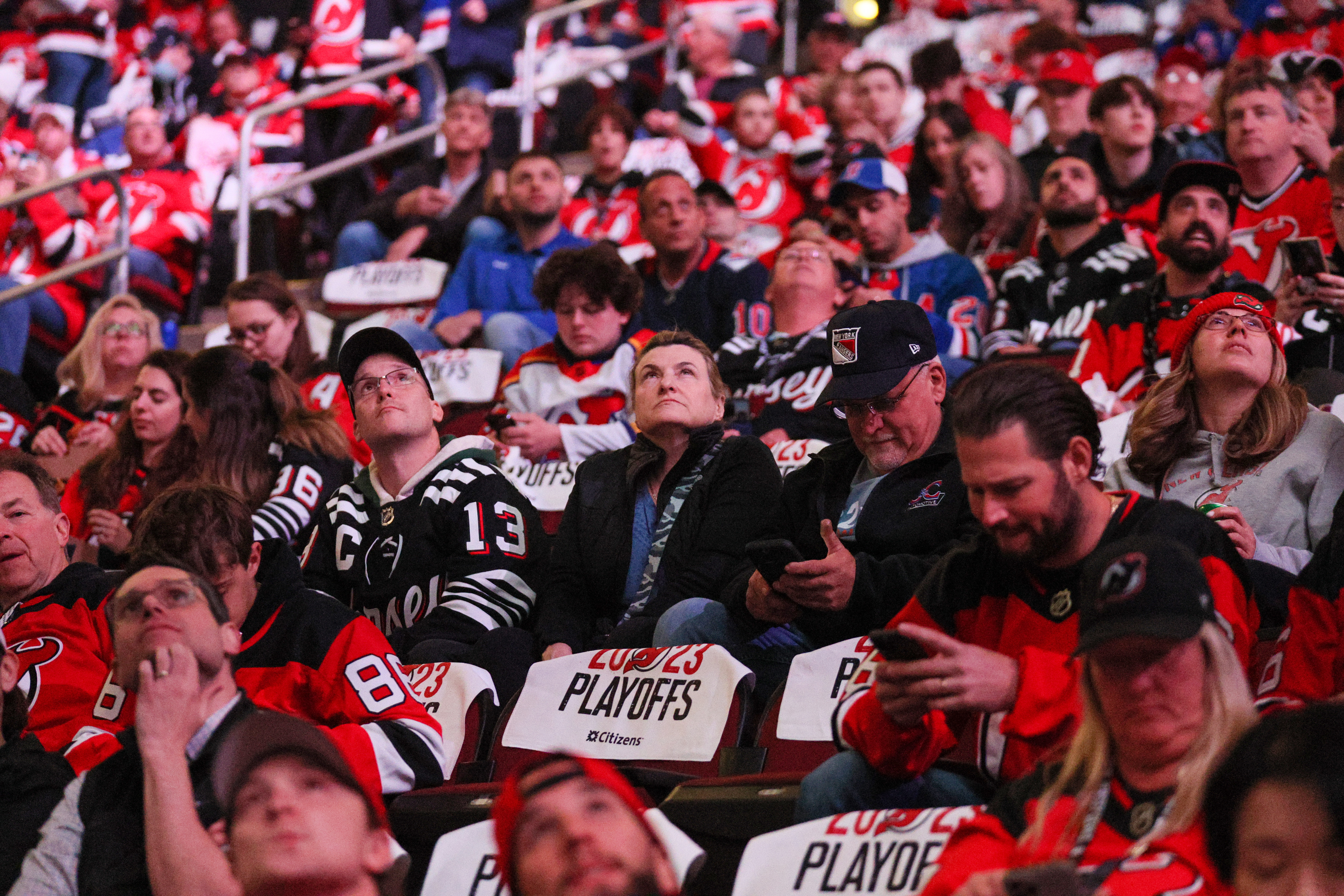 Fans watch the Jumbotron before the start of the New Jersey Devils - New York Rangers Stanley Cup playoffs game on Tuesday, April 18, 2023 in Newark, N.J. 