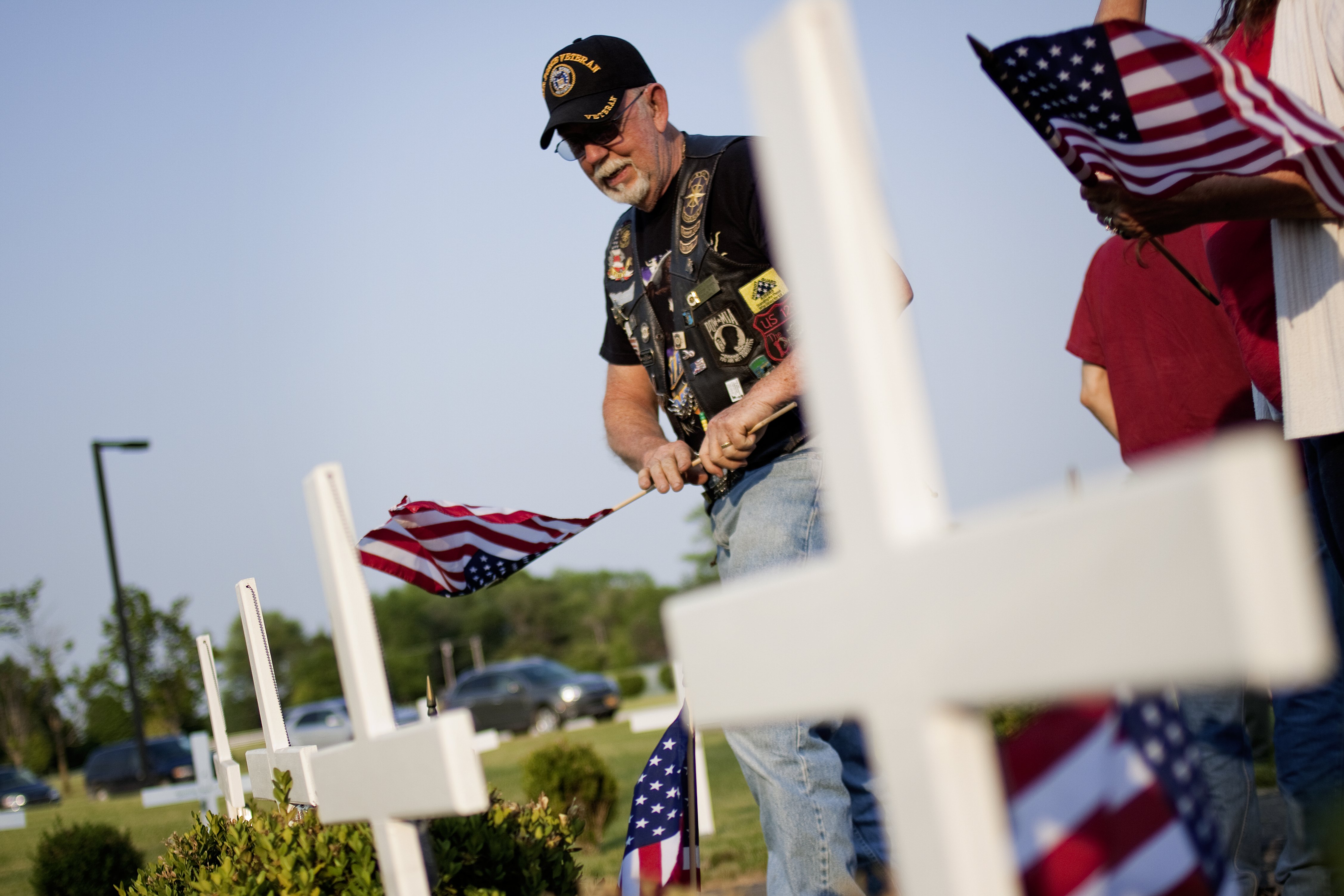 Members of Baseball Team Help Place Flags for Memorial Day