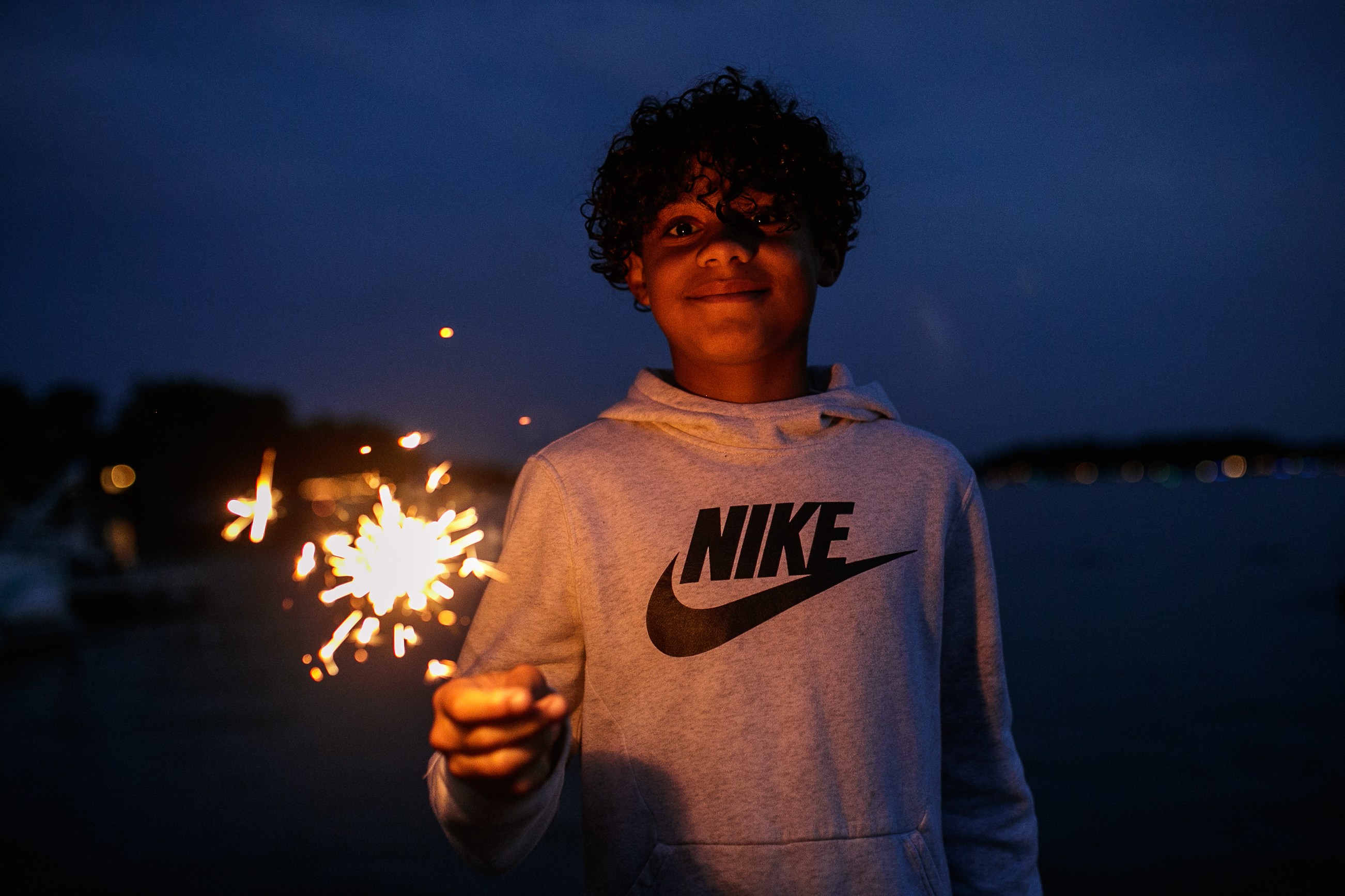 Brodi Jourdan, 10,  plays with a sparkler while waiting for the start of the annual Lake Fenton Fireworks on the water in front of the Township hall on Saturday, June 2, 2022 in Fenton Township. (Jenifer Veloso | MLive.com)


