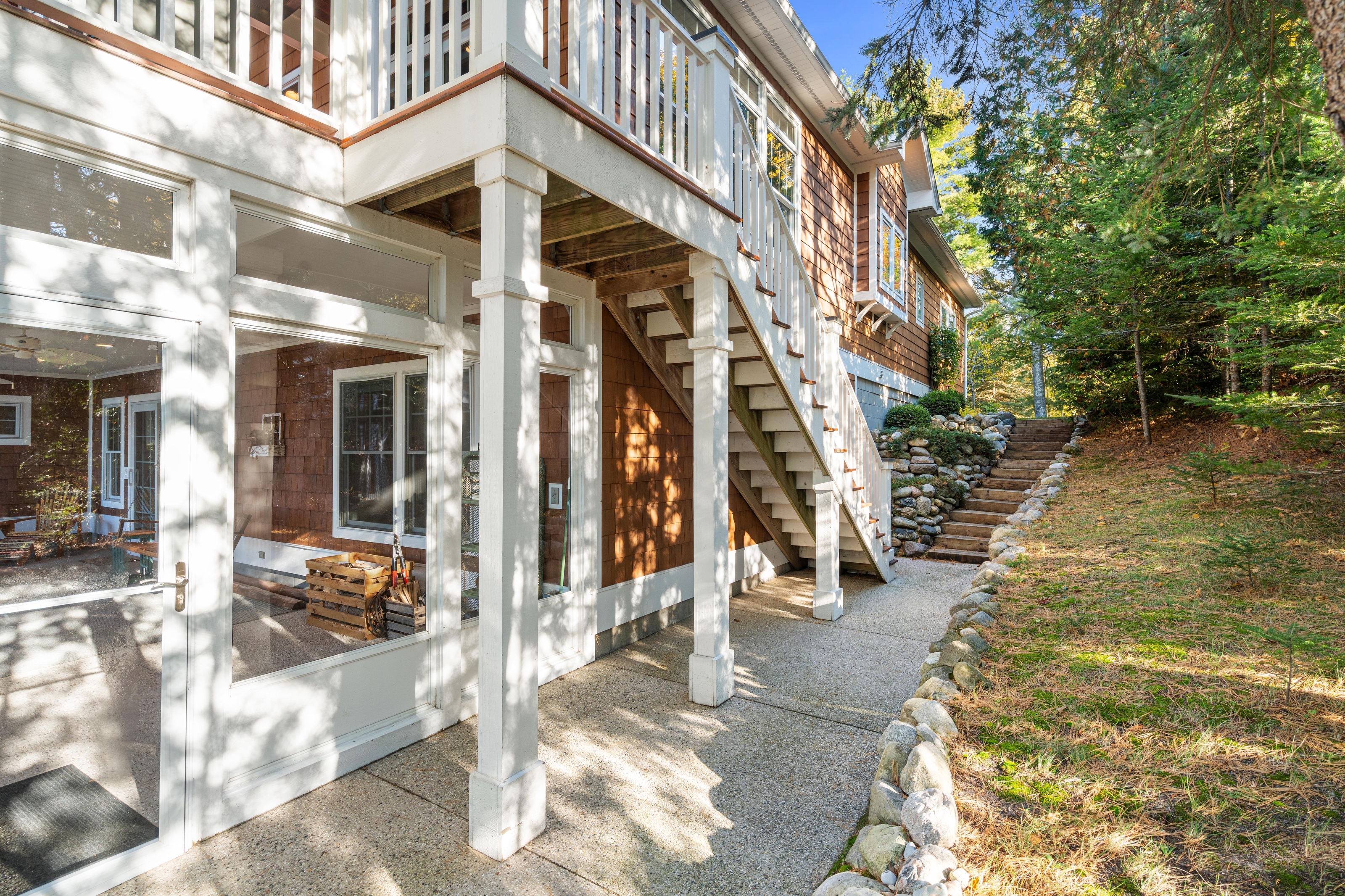 Exterior photographs of 4093 Lake Shore Drive in Charlevoix, this gem is listed at $2,099,900 through Berkshire Hathaway HomeServices Michigan Real Estate – Traverse City and The Crane Group with associate broker Johnny Crane and his brother, co-listing agent Matt Crane.