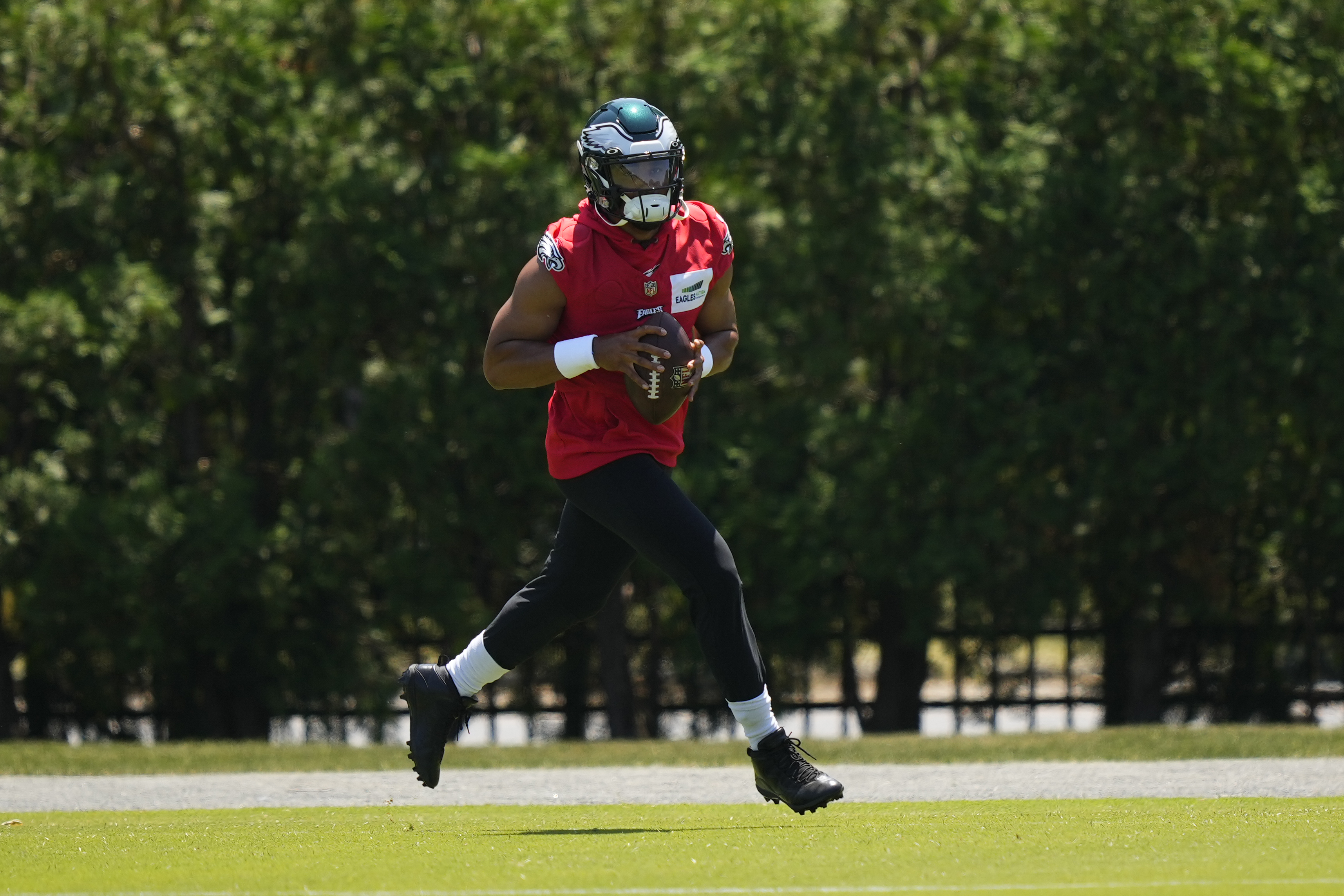 Eagles' Jalen Hurts connects with his receivers during OTA session