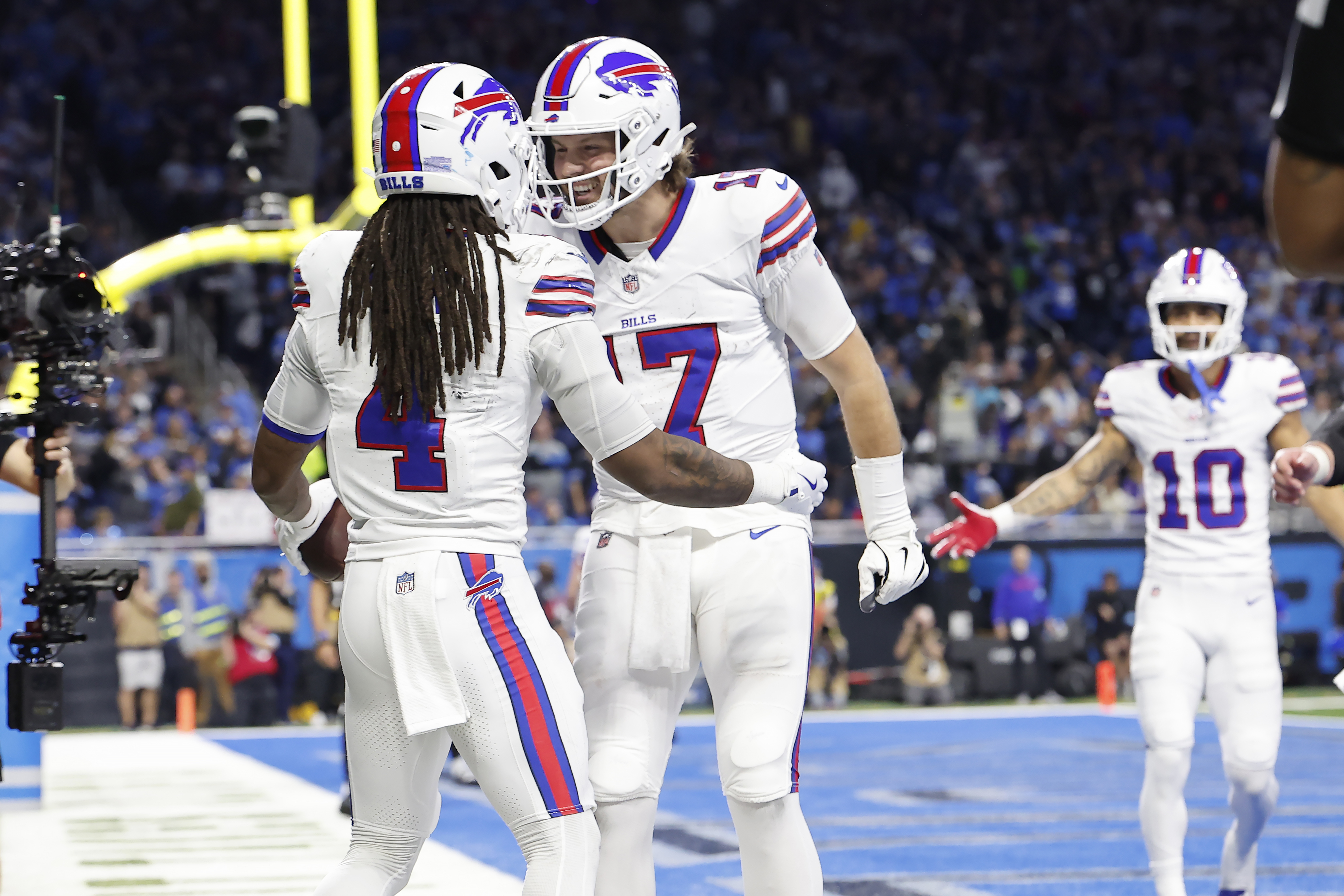 Buffalo Bills running back James Cook (4) celebrates quarterback Josh Allen (17) after scoring against the Detroit Lions during the first half of an NFL football game, Sunday, Dec. 15, 2024, in Detroit. (AP Photo/Rey Del Rio)