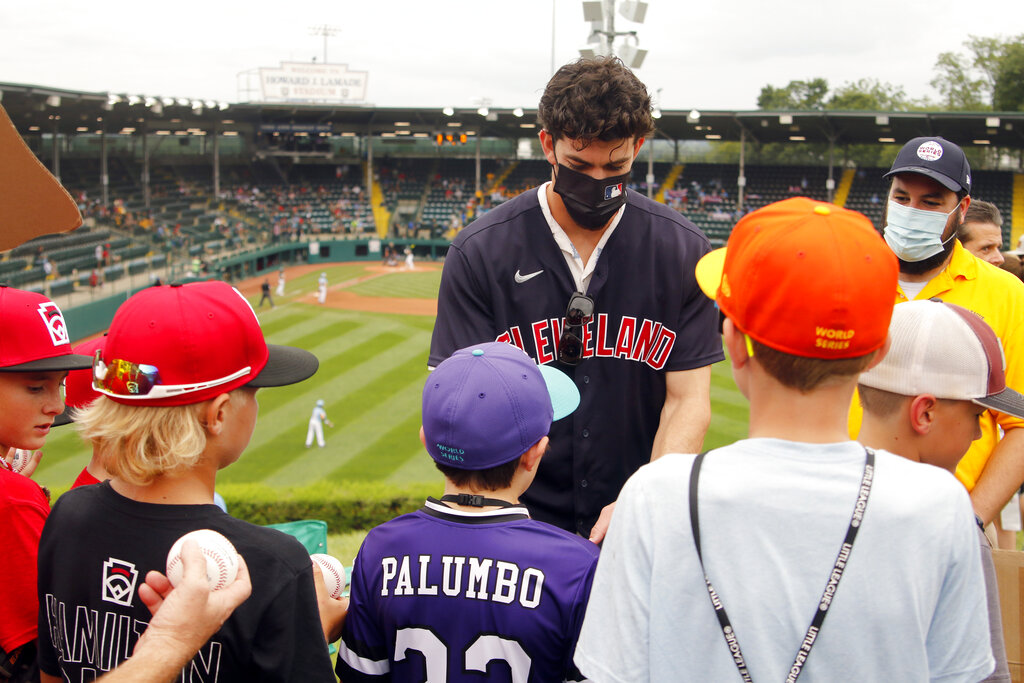 Cleveland Indians' Zach Plesac signs a hat for Nolensville, Tenn.'s Drew  Wagner (19) while they watch the game between Honolulu, Hawaii and  Hastings, Neb. during the a baseball game at the Little